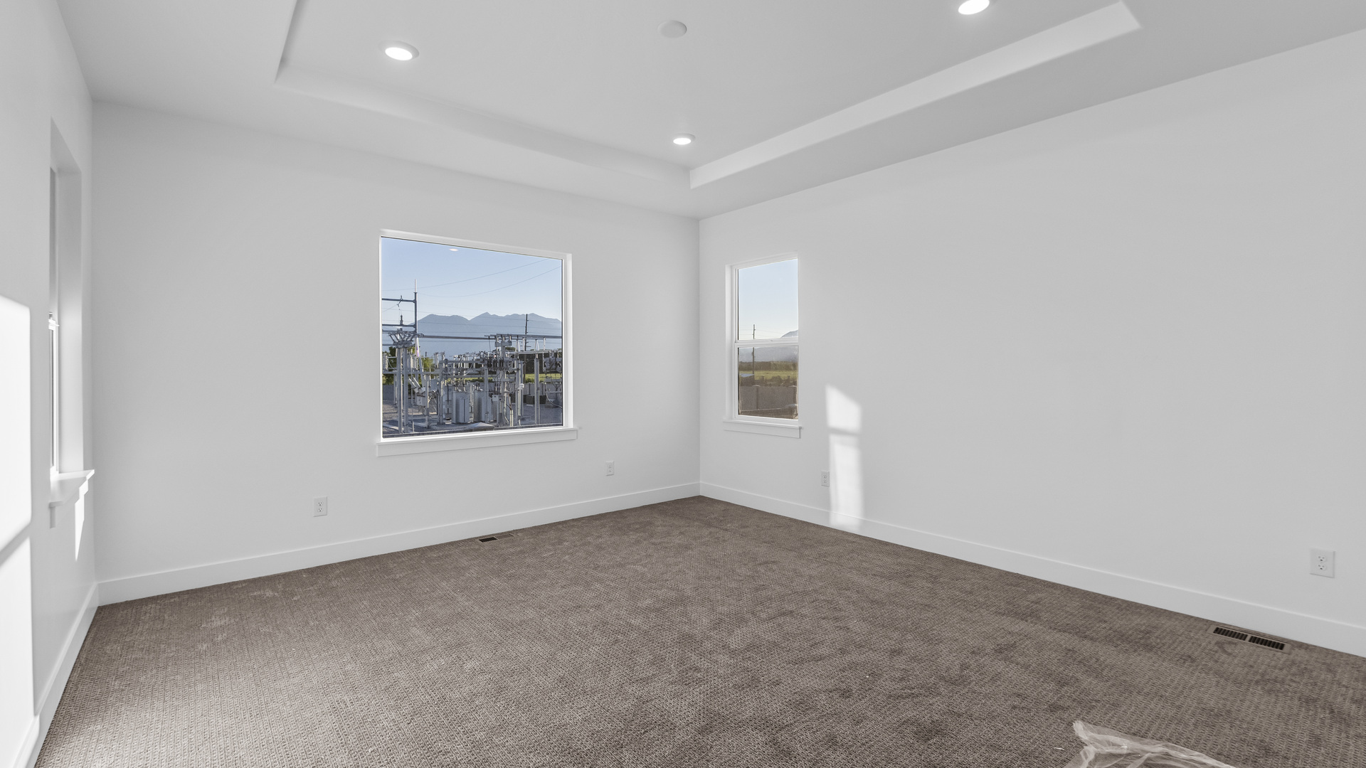 Primary bedroom with large windows