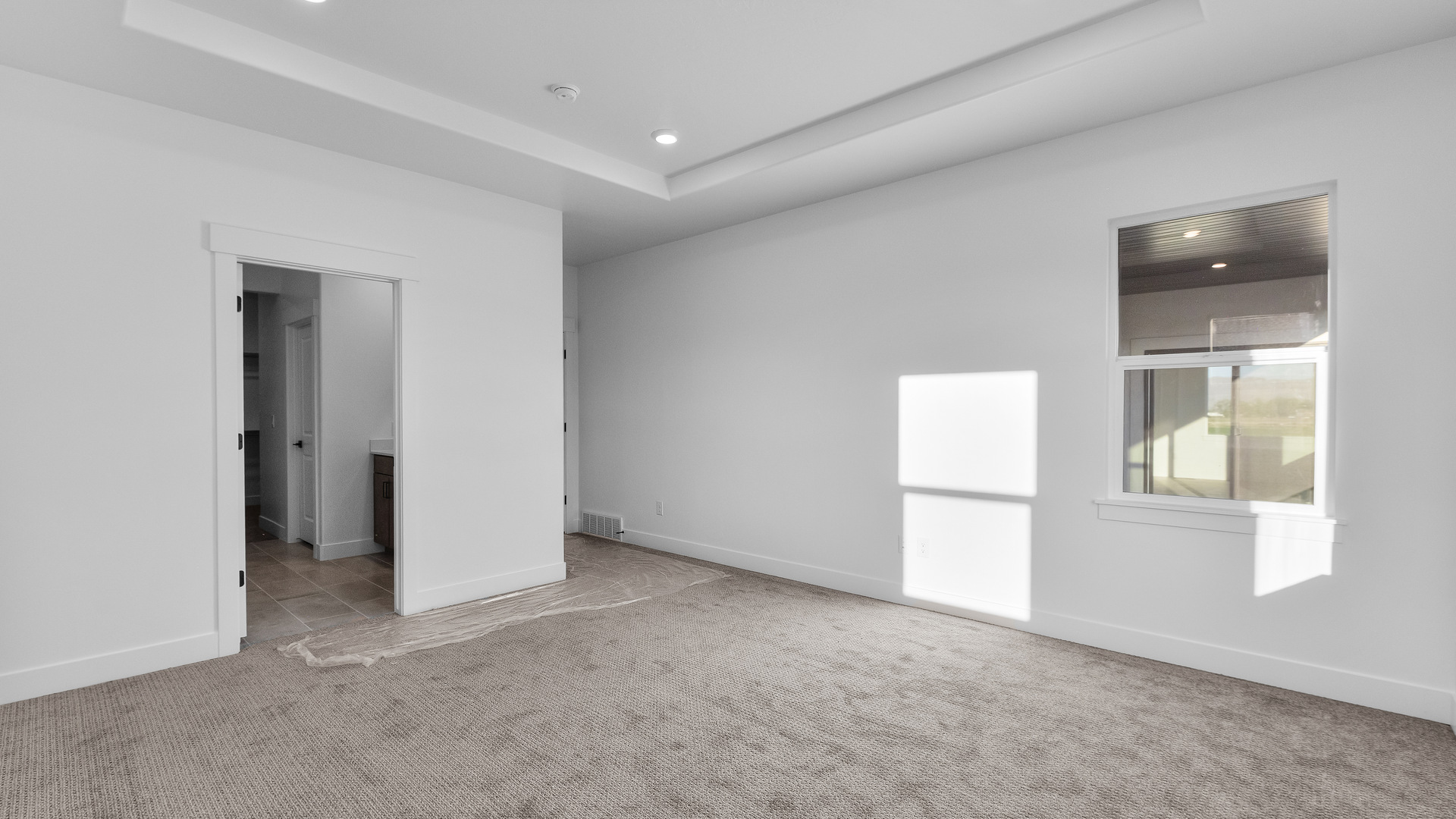 Primary bedroom with large windows