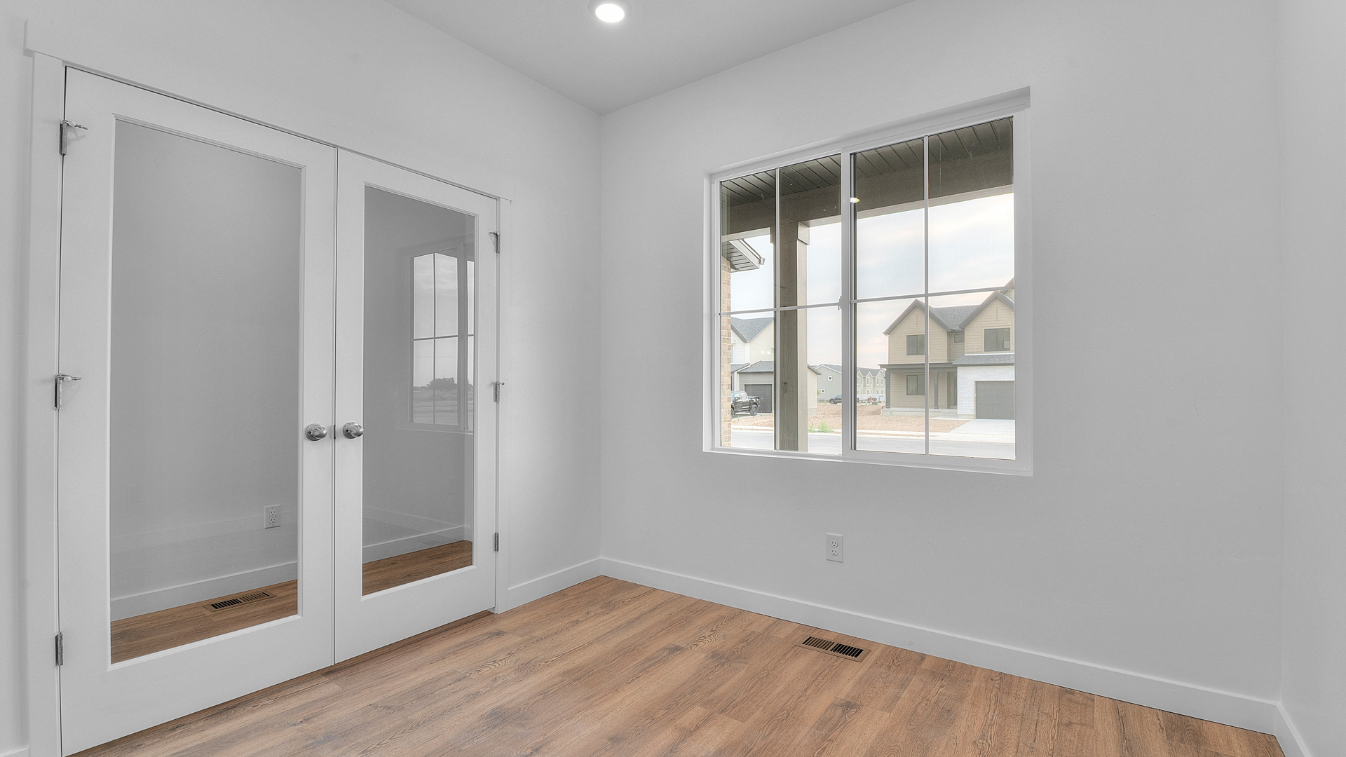 Office space with double doors and large window.