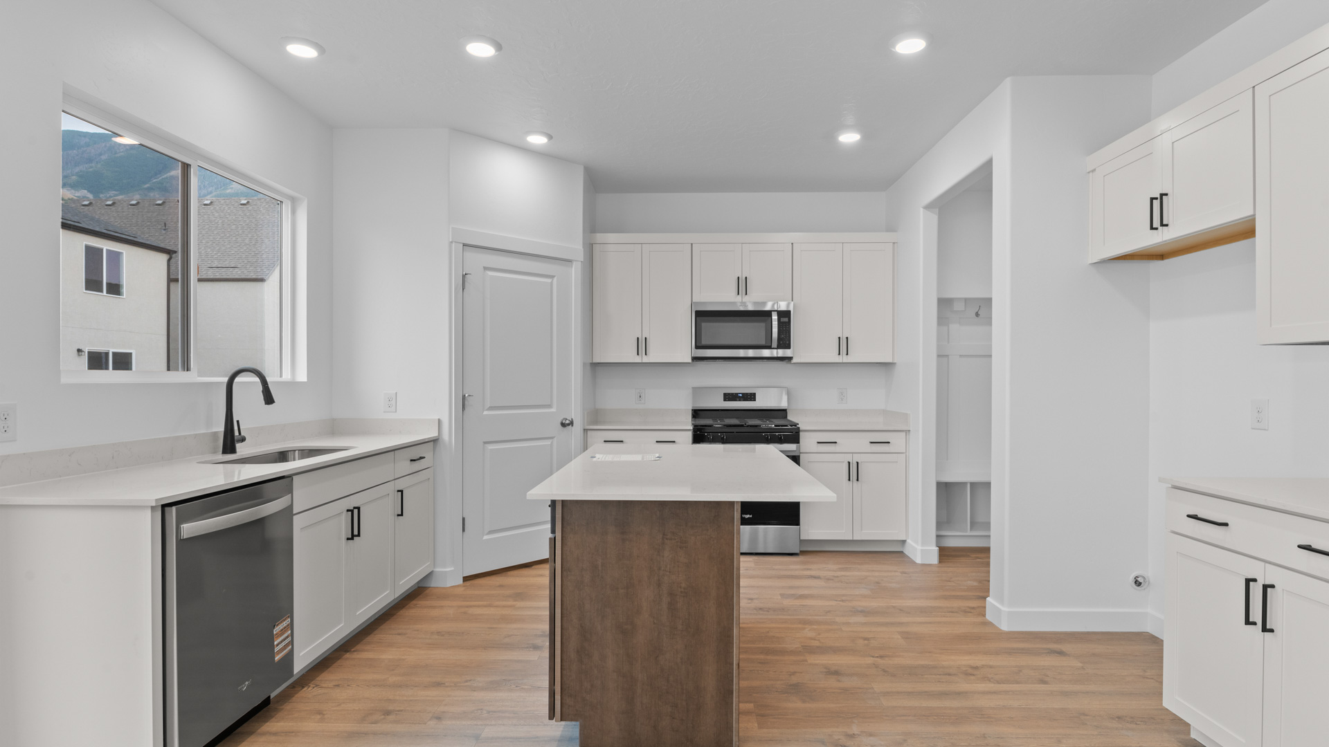 Kitchen with kitchen island and stainless steel appliances.