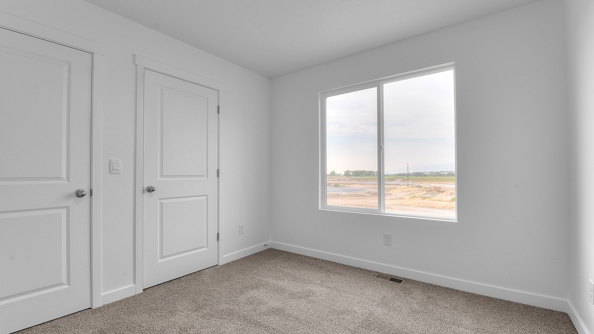 Bedroom with large window.