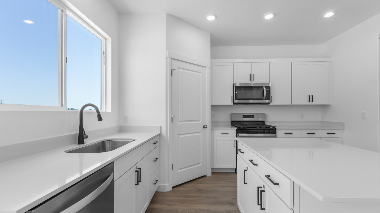 Kitchen with kitchen island and stainless steel appliances.
