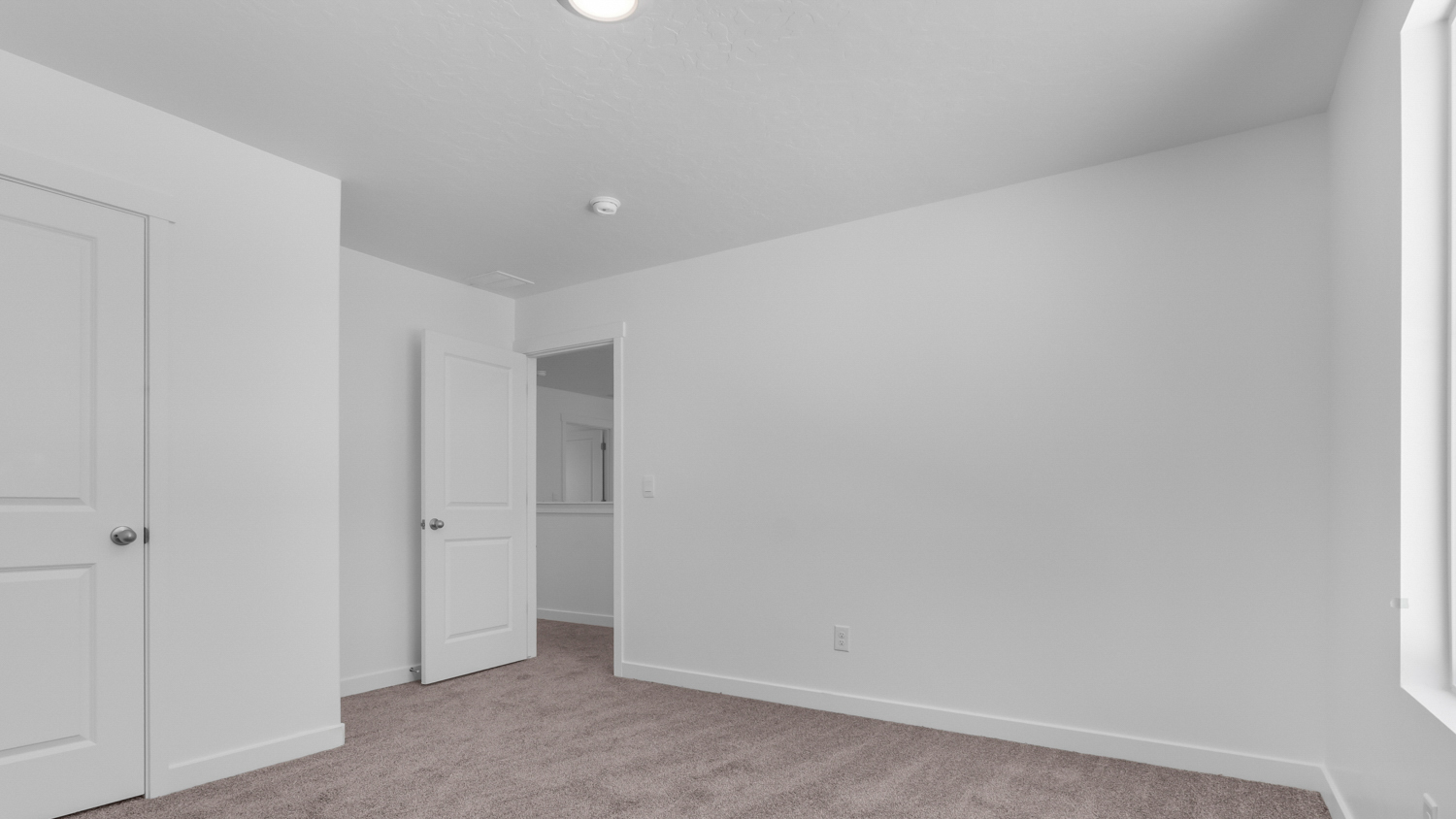 Upstairs bedroom with large window.
