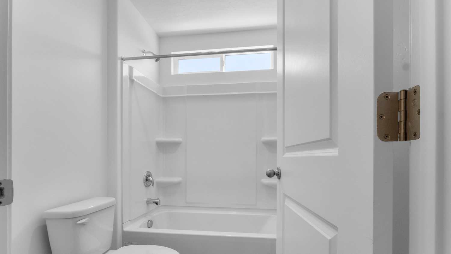 Bathroom with shower surround and window above.