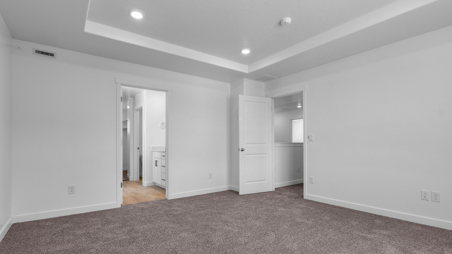 Primary bedroom with tray ceiling.