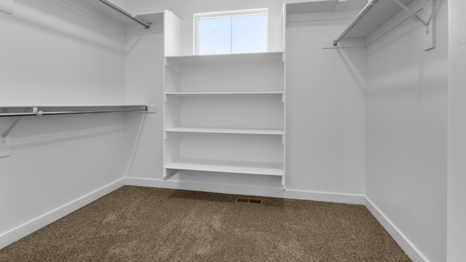 Primary walk-in closet with window.