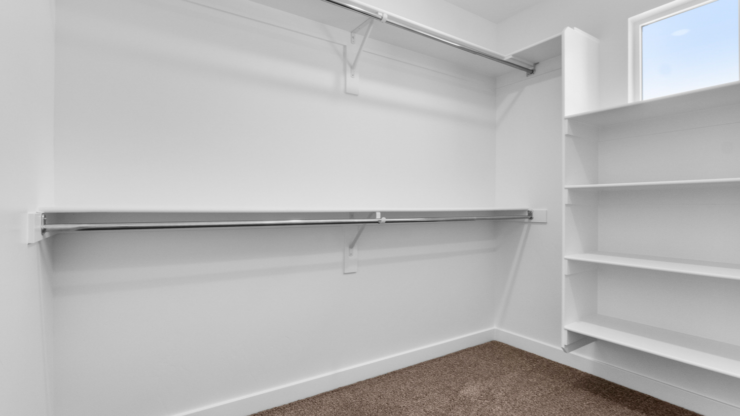 Primary walk-in closet with window.