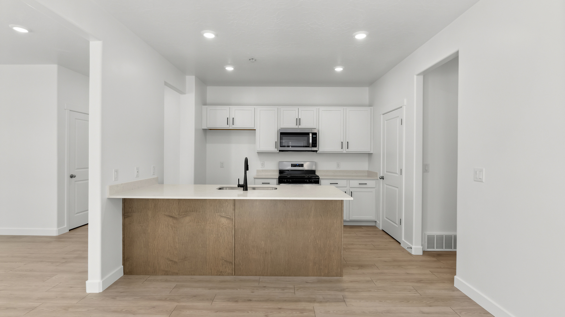 Kitchen with kitchen island and stainless steel appliances.