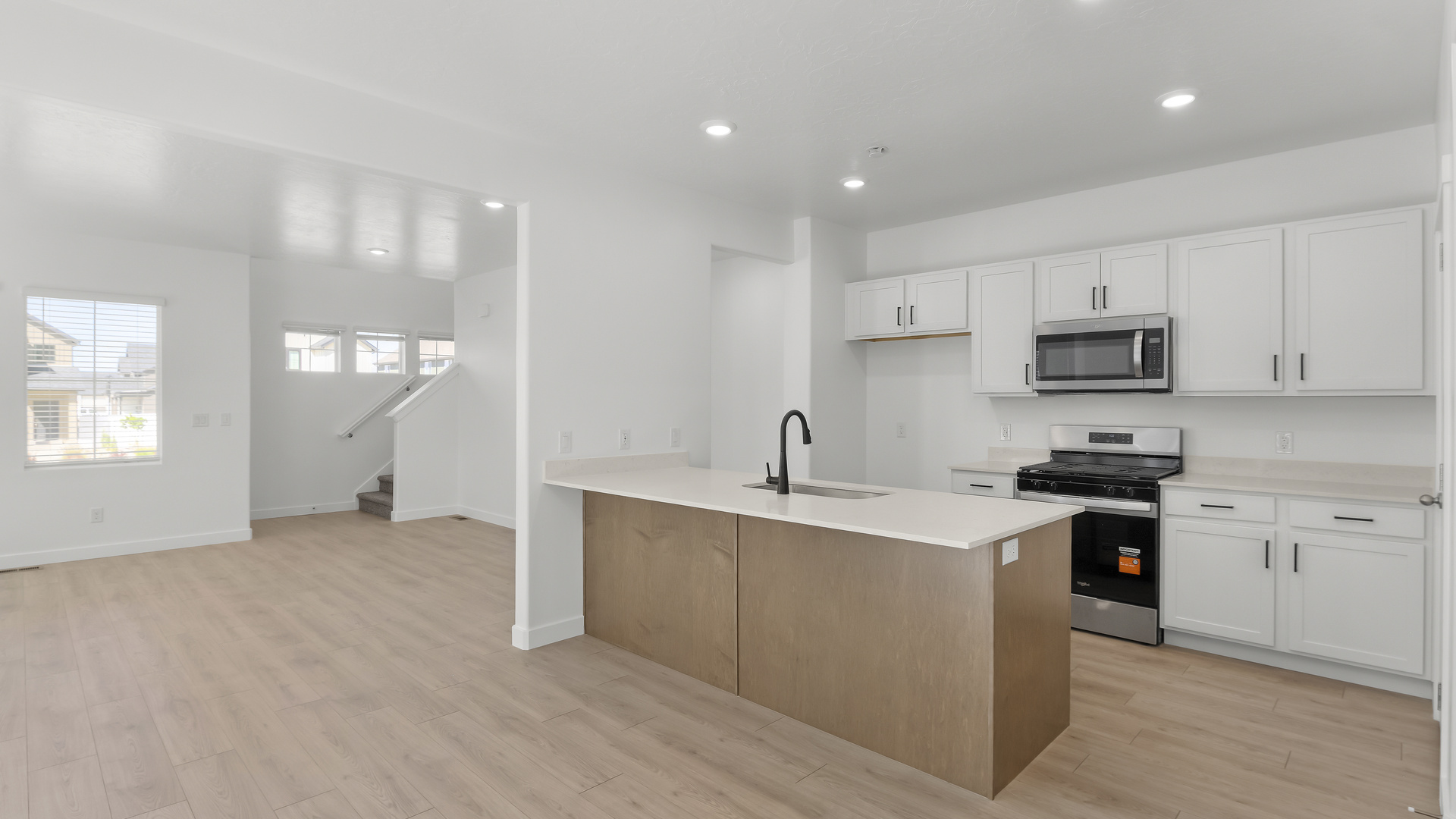 Kitchen with kitchen island and stainless steel appliances.