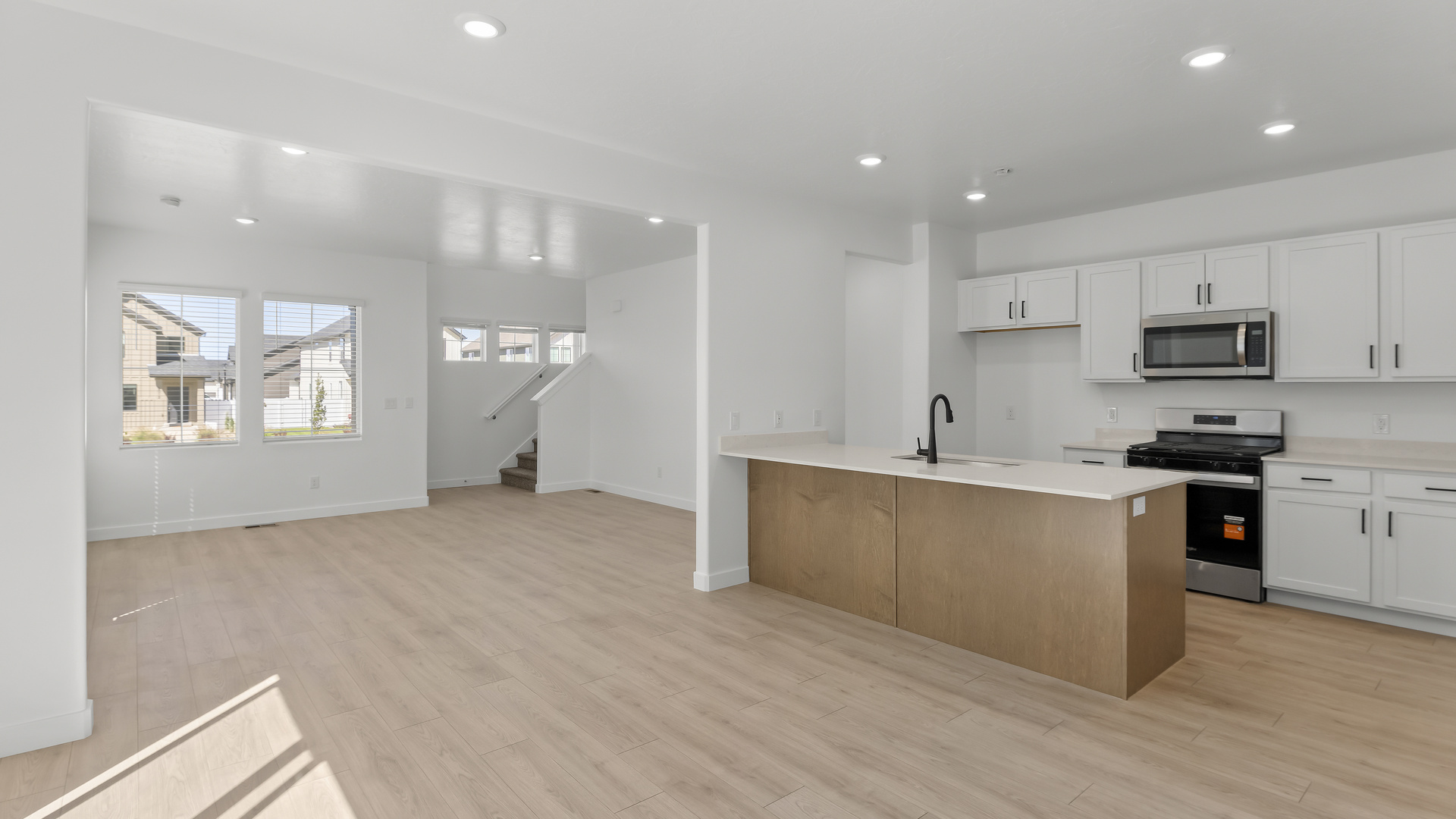 Kitchen with kitchen island and stainless steel appliances.