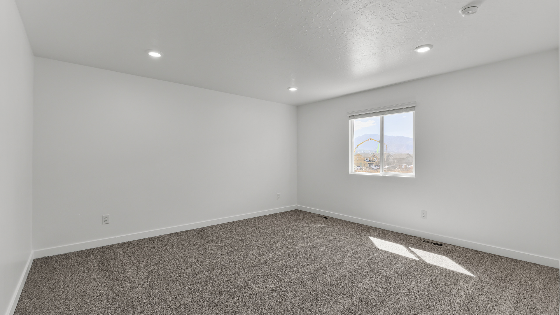 Primary bedroom with large window.