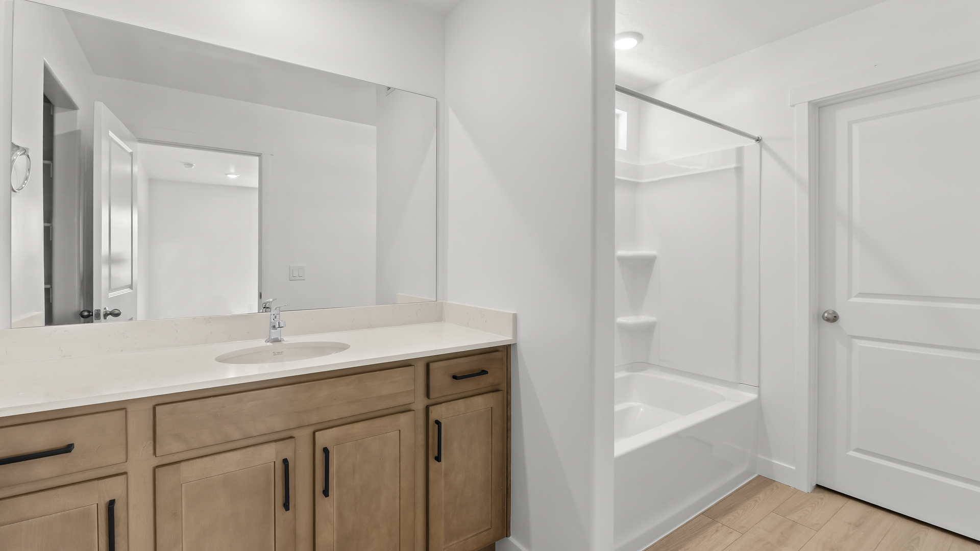 Primary bathroom with shower surround.