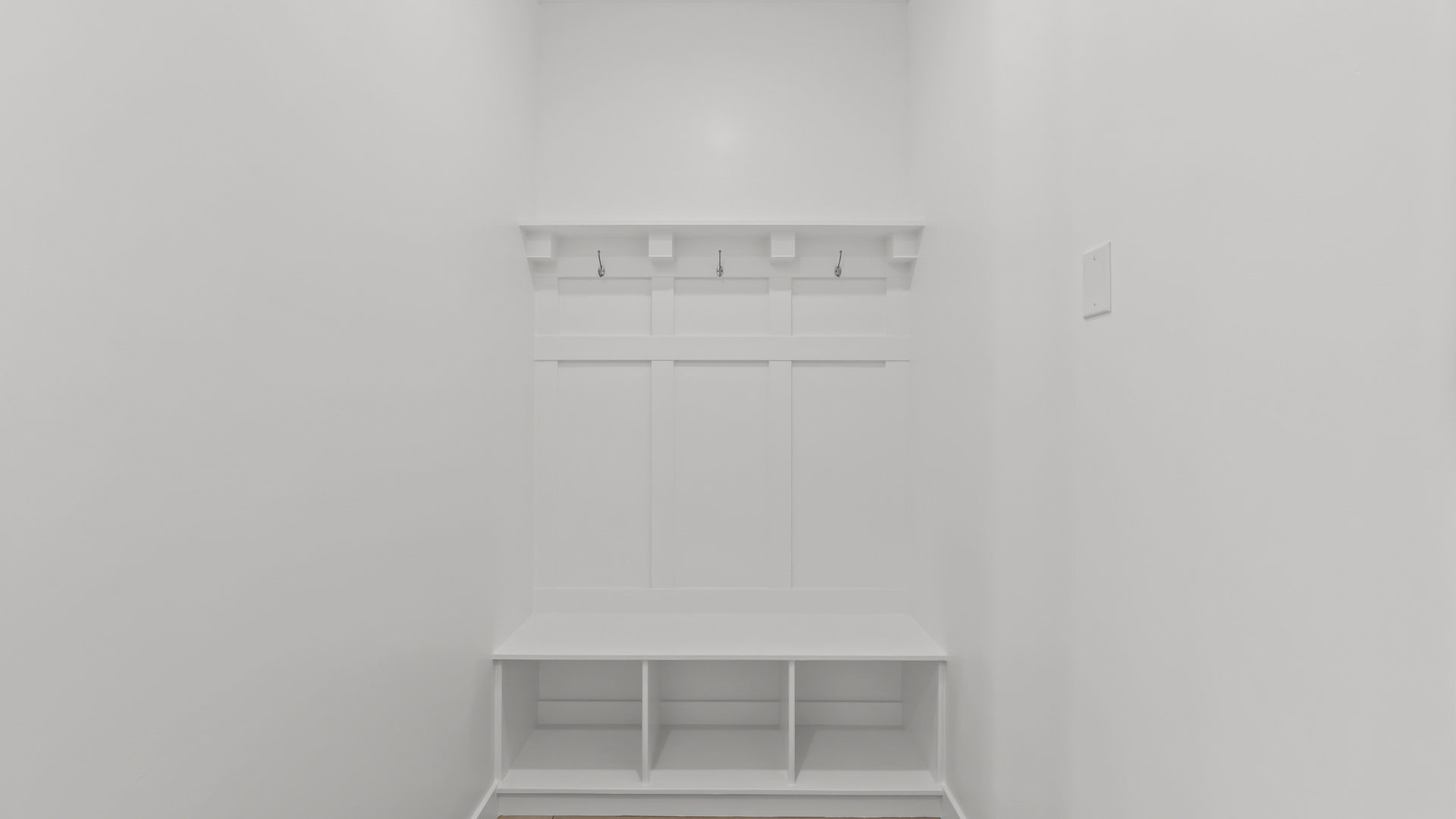 Mudroom off garage with mudroom bench.