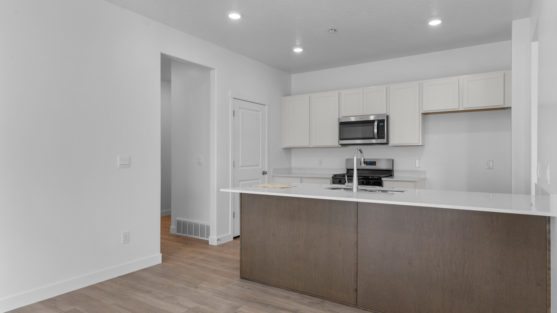 Kitchen with kitchen island and stainless steel appliances.