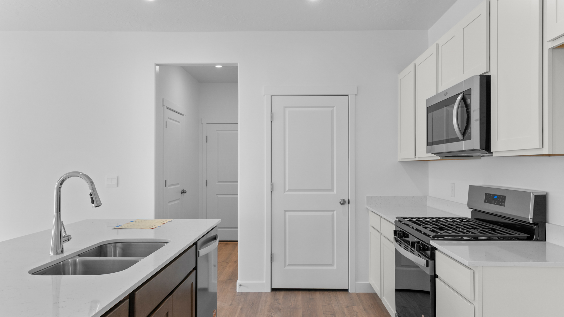 Kitchen with kitchen island and stainless steel appliances.