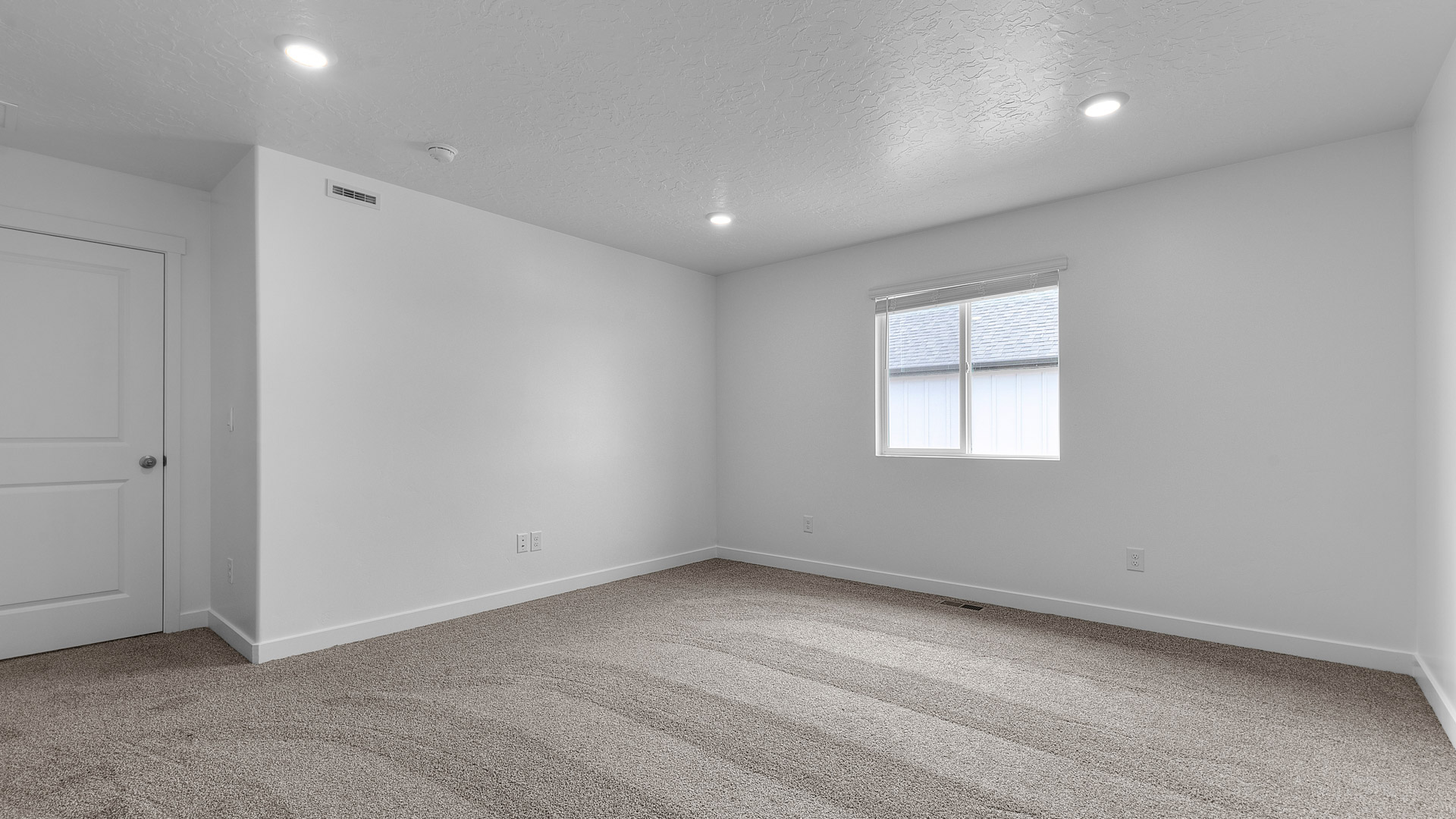 Primary bedroom with window.