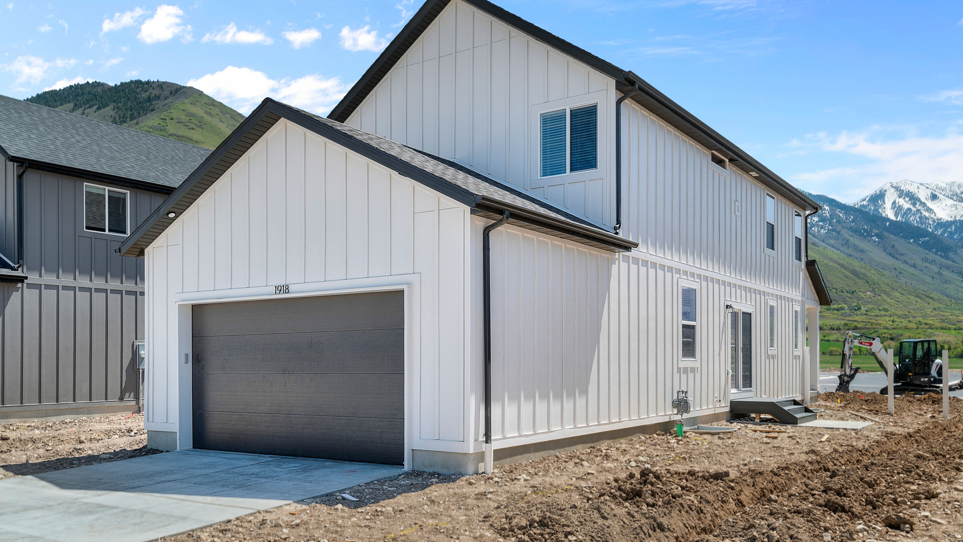 Back of home with garage.