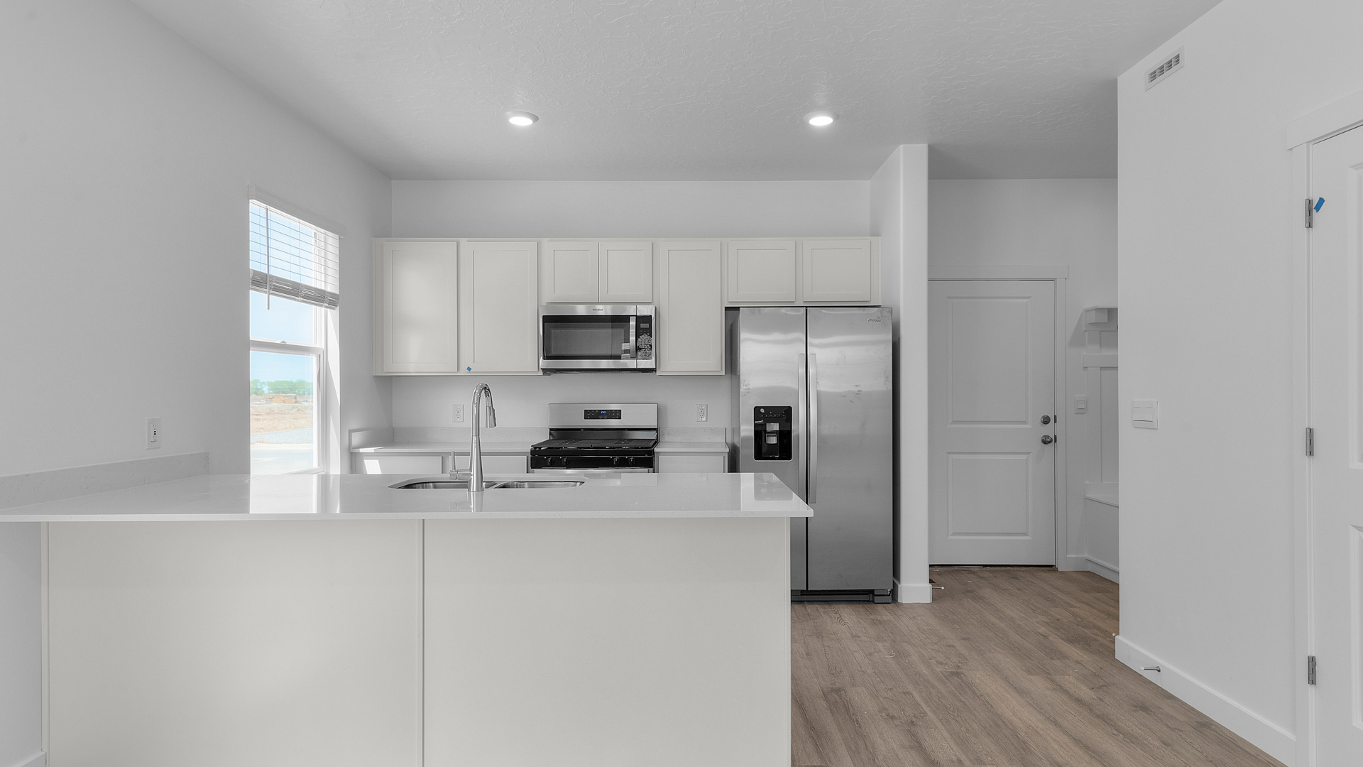 Kitchen with kitchen island and stainless steel appliances.