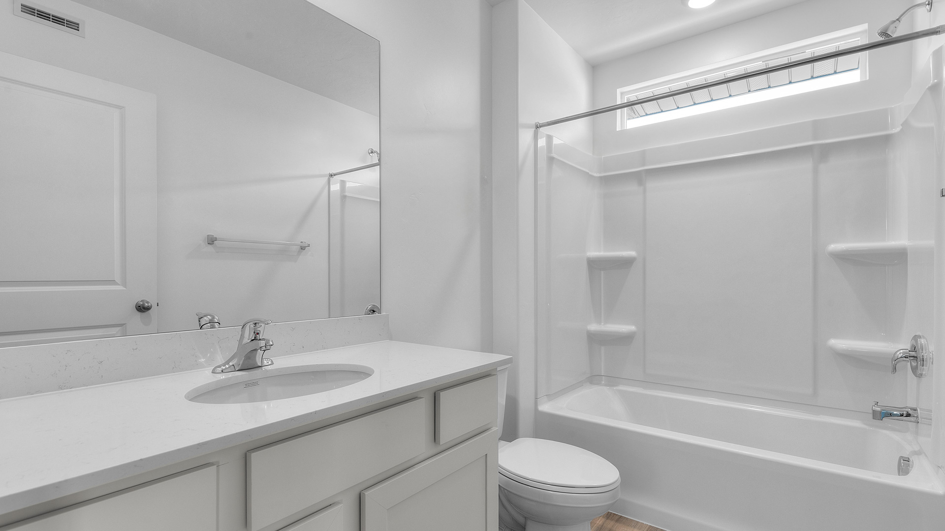 Bathroom with shower surround and window above.