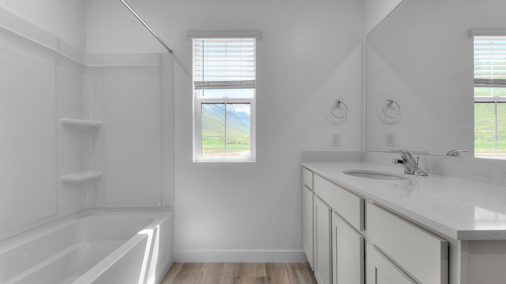 Primary bathroom with window and shower surround.