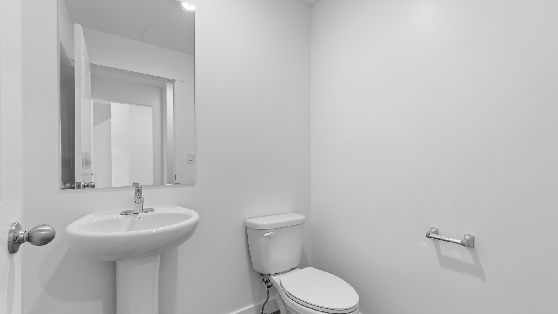 Powder room with pedestal sink and toilet.