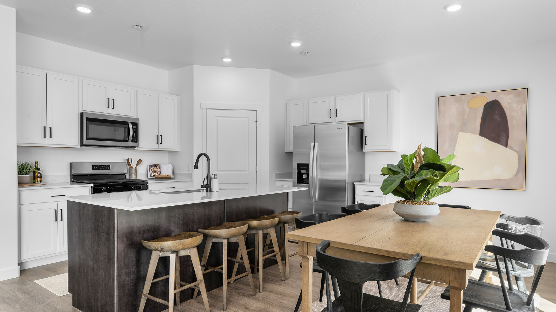 Focusing on the dining area where there is room for a 6 seat dining table including a stylish hanging light over the dining table and sliding glass doors leading to the back patio.