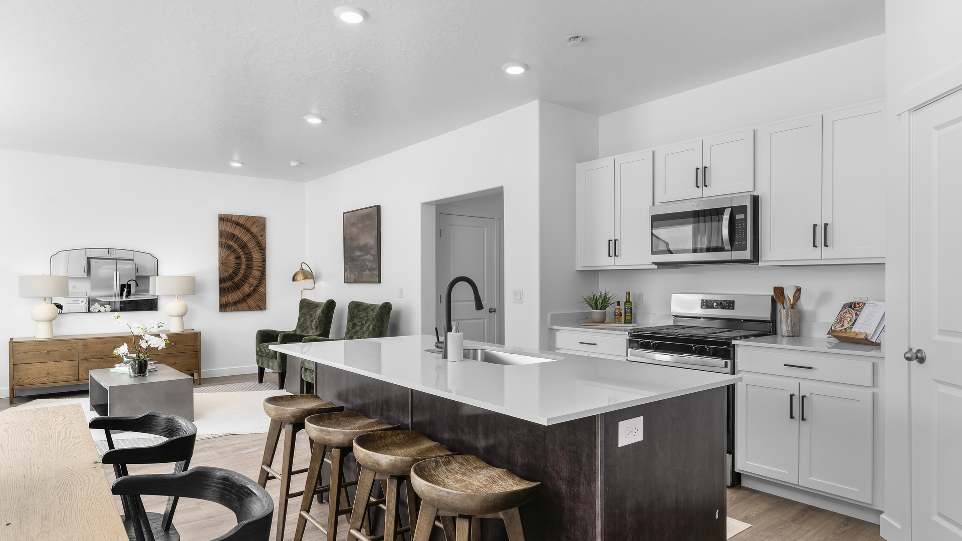 Spacious kitchen with kitchen island and sink, cabinets, and stainless steel appliances.