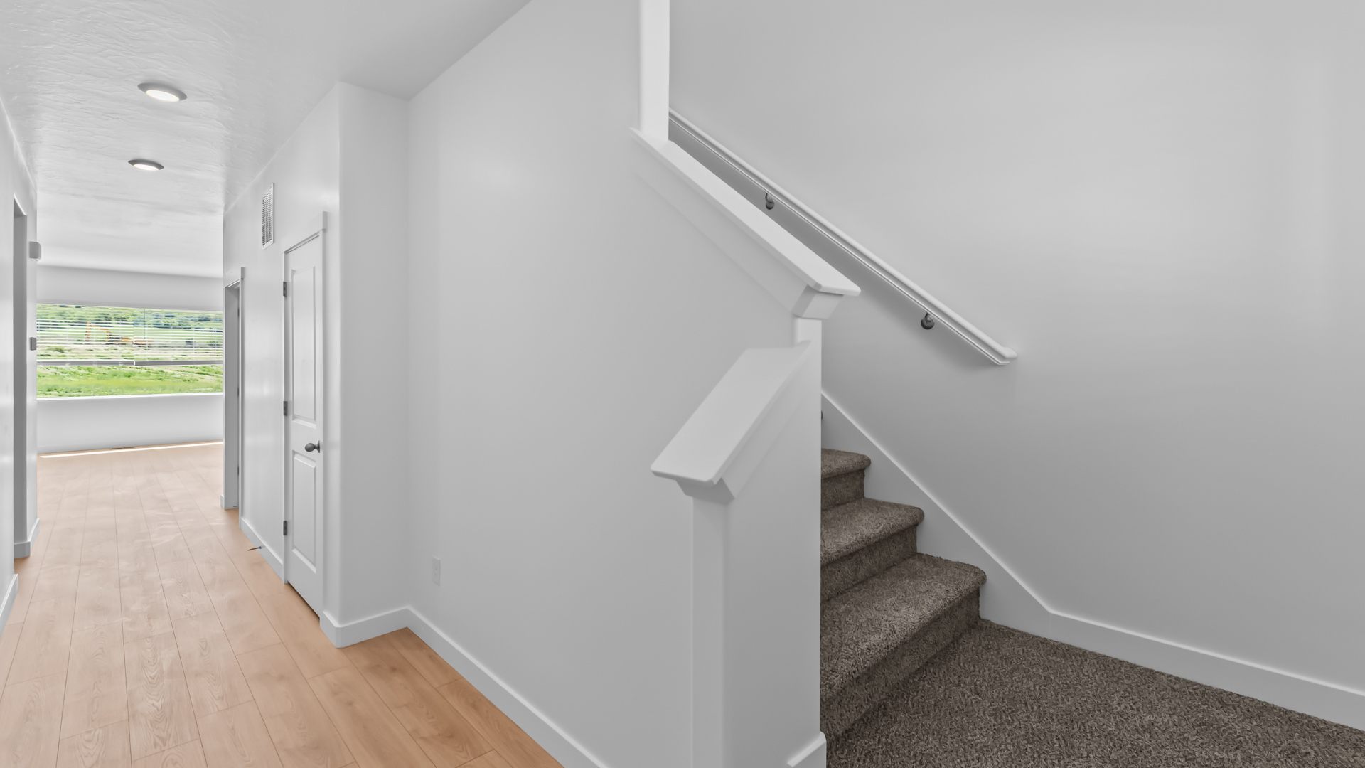 Spacious entry into main living space and access to upstairs.