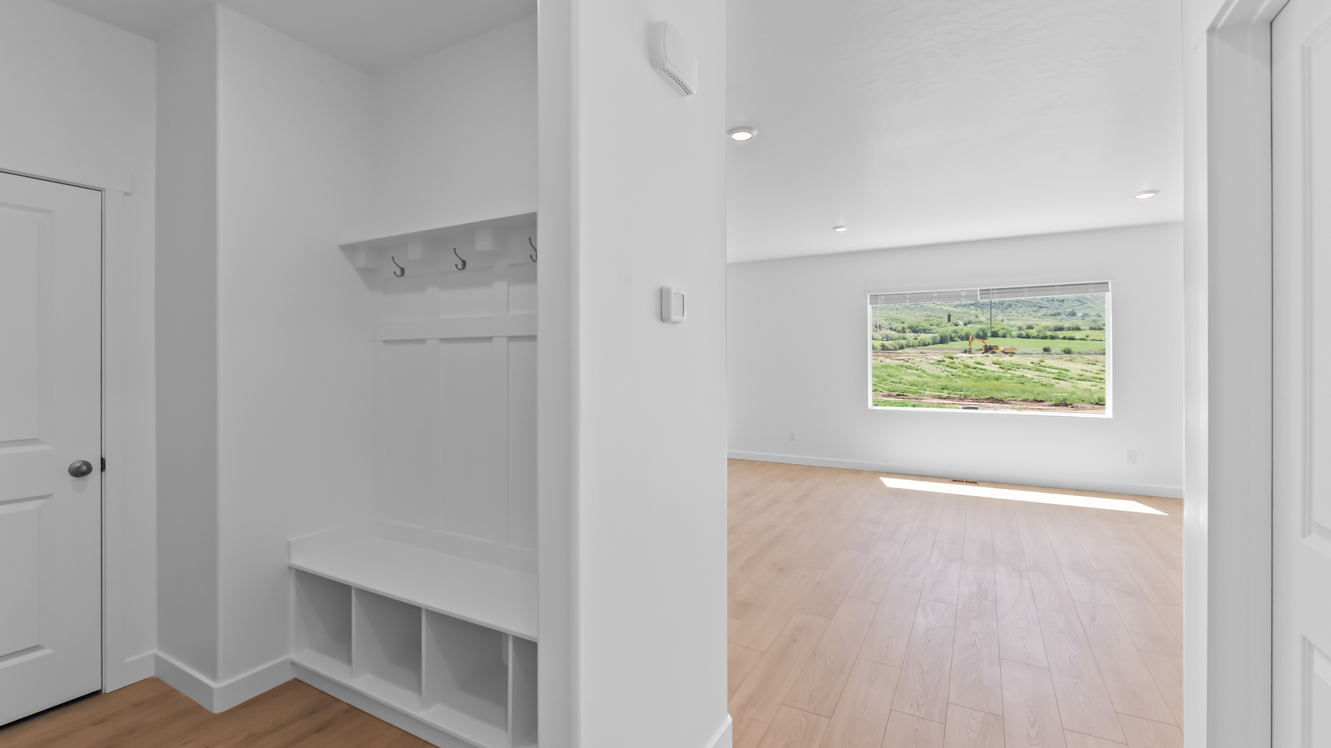 Mudroom with mudroom storage bench and hooks.