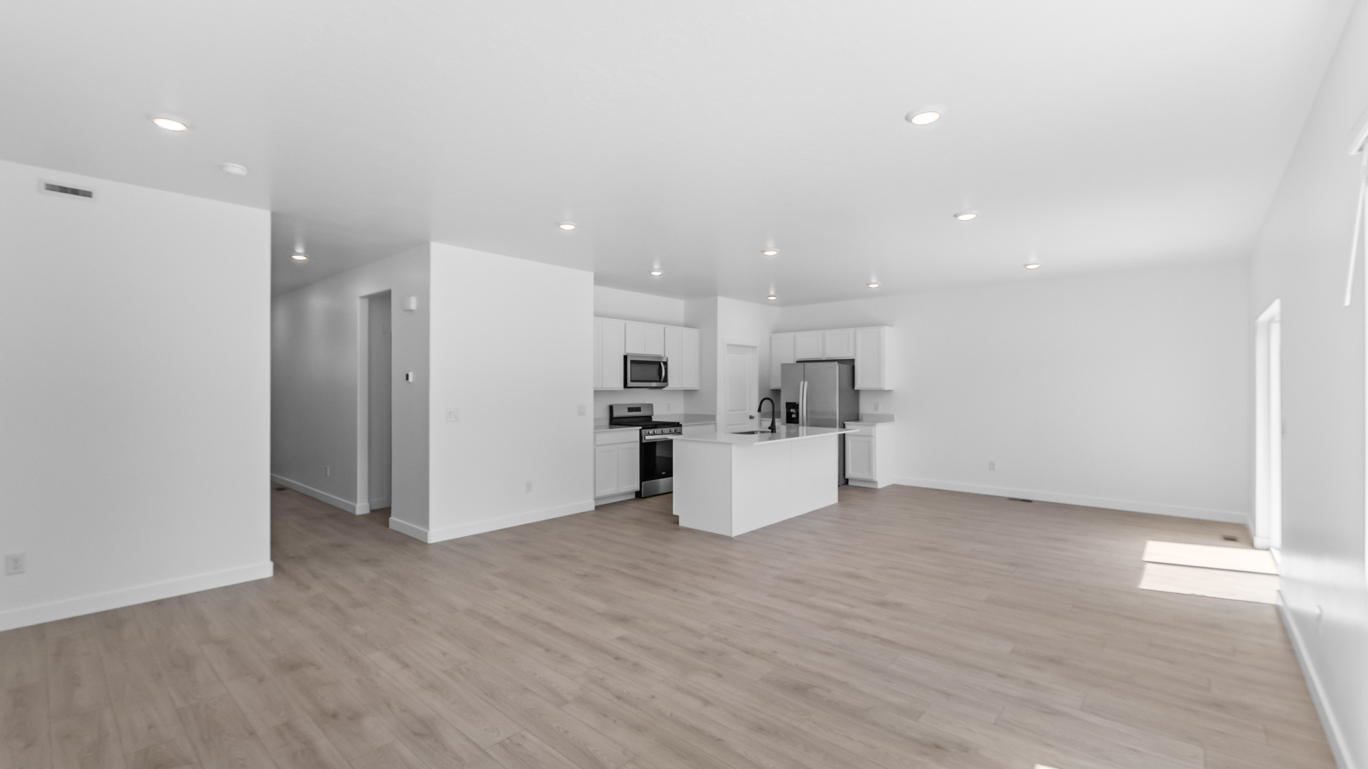 Kitchen space with kitchen island and stainless steel appliances.