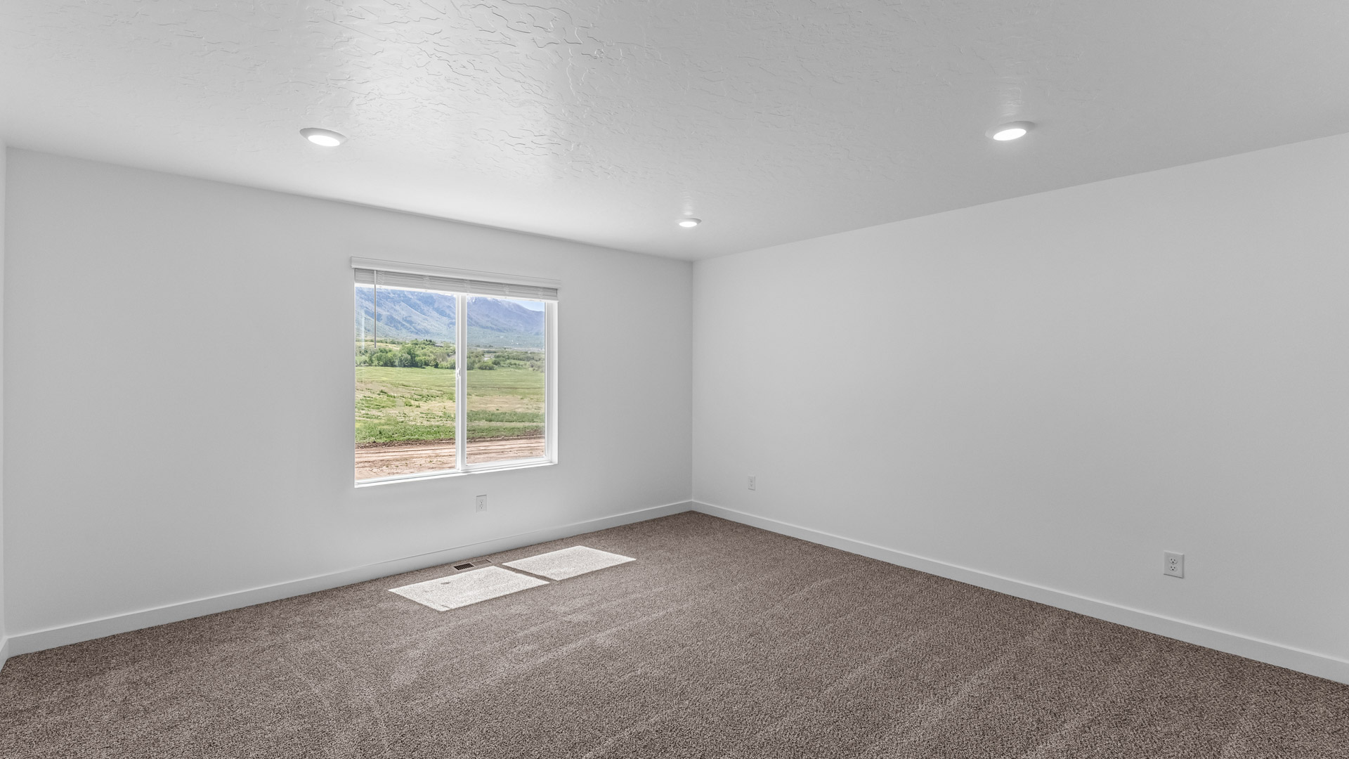 Primary bedroom with large window.