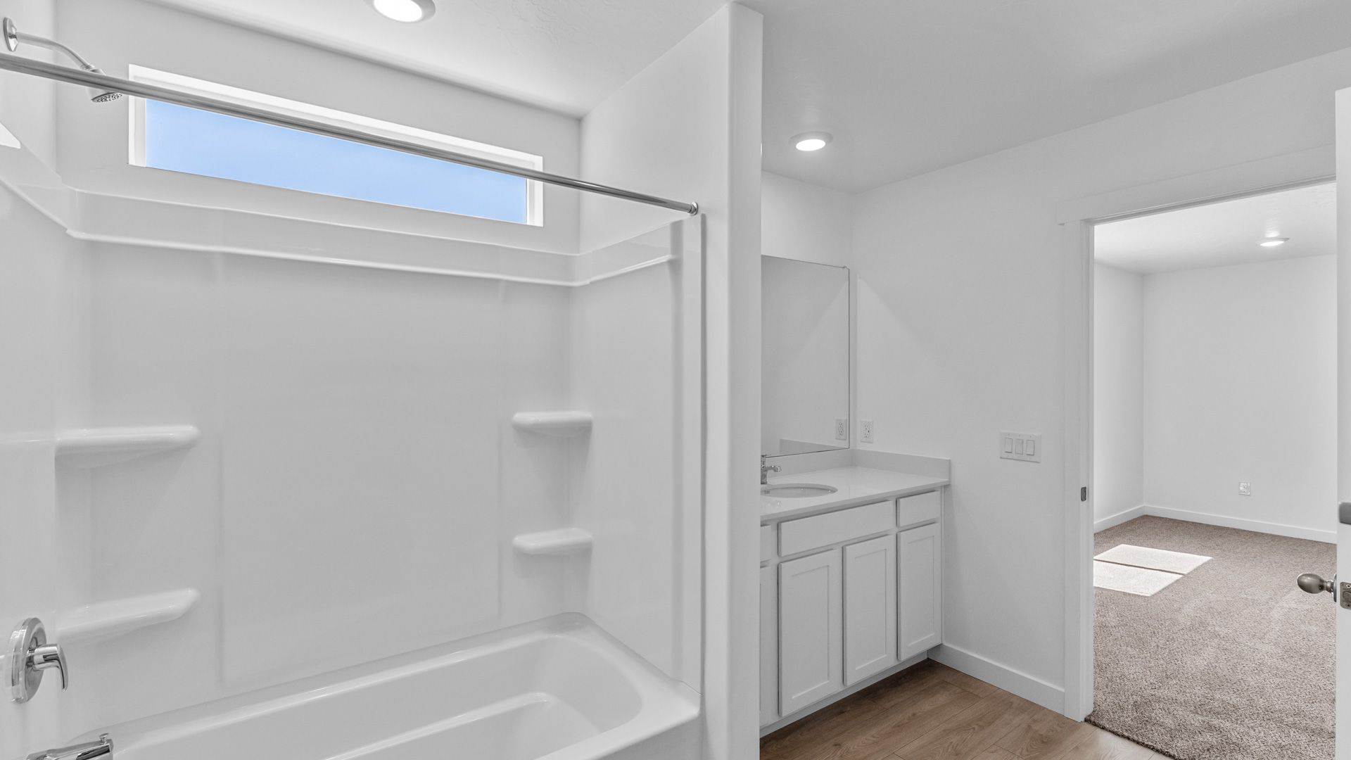 Primary bathroom with large vanity and shower surround.