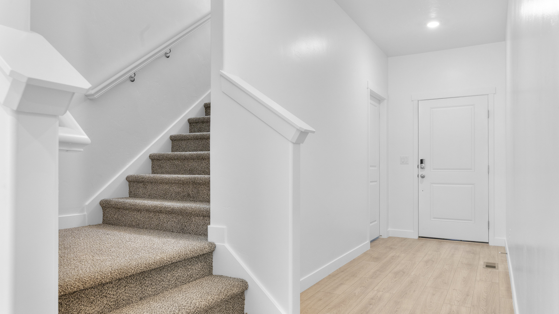 Spacious entry into main living space and access to upstairs.