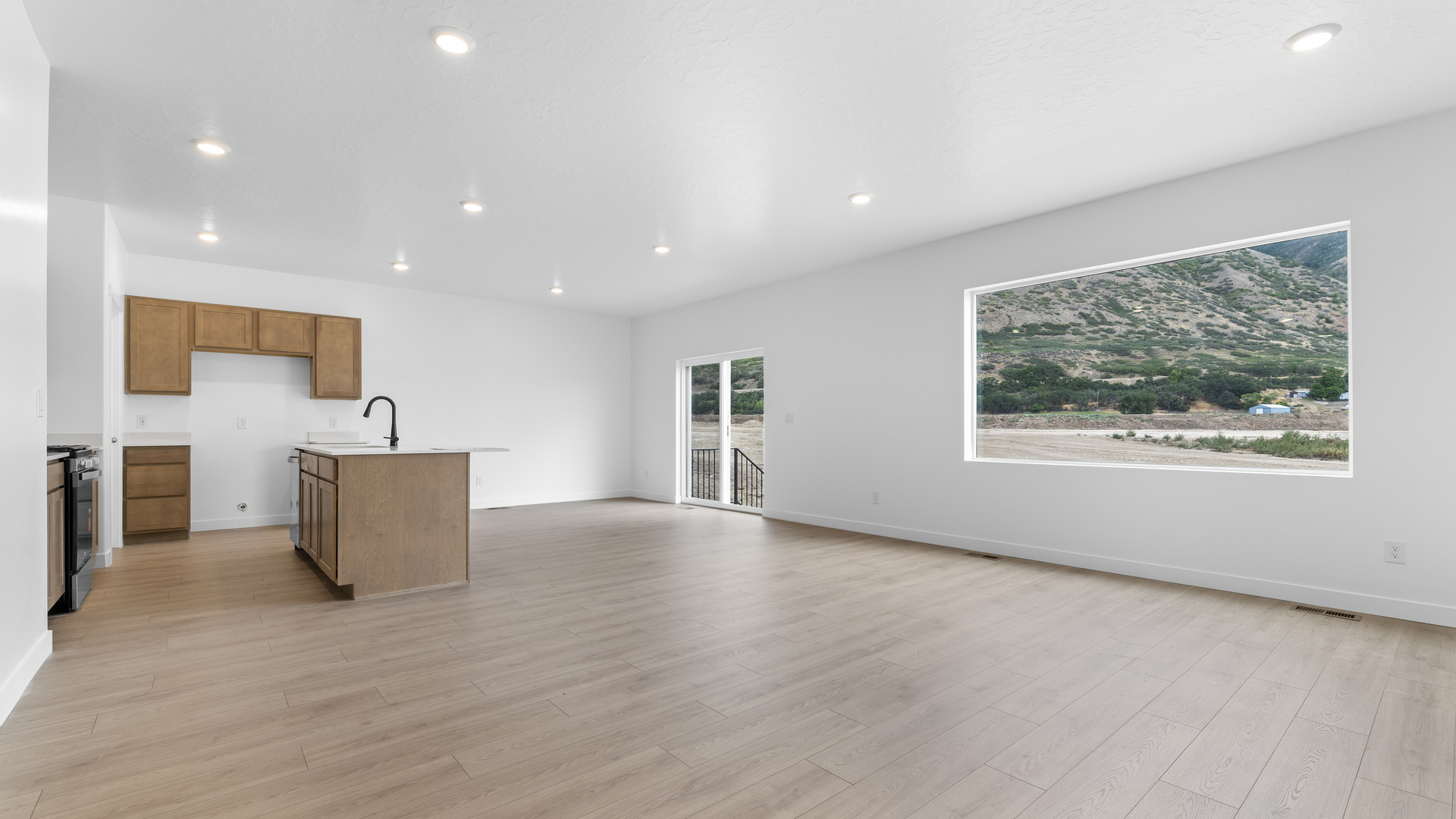 Kitchen space with kitchen island and stainless steel appliances.