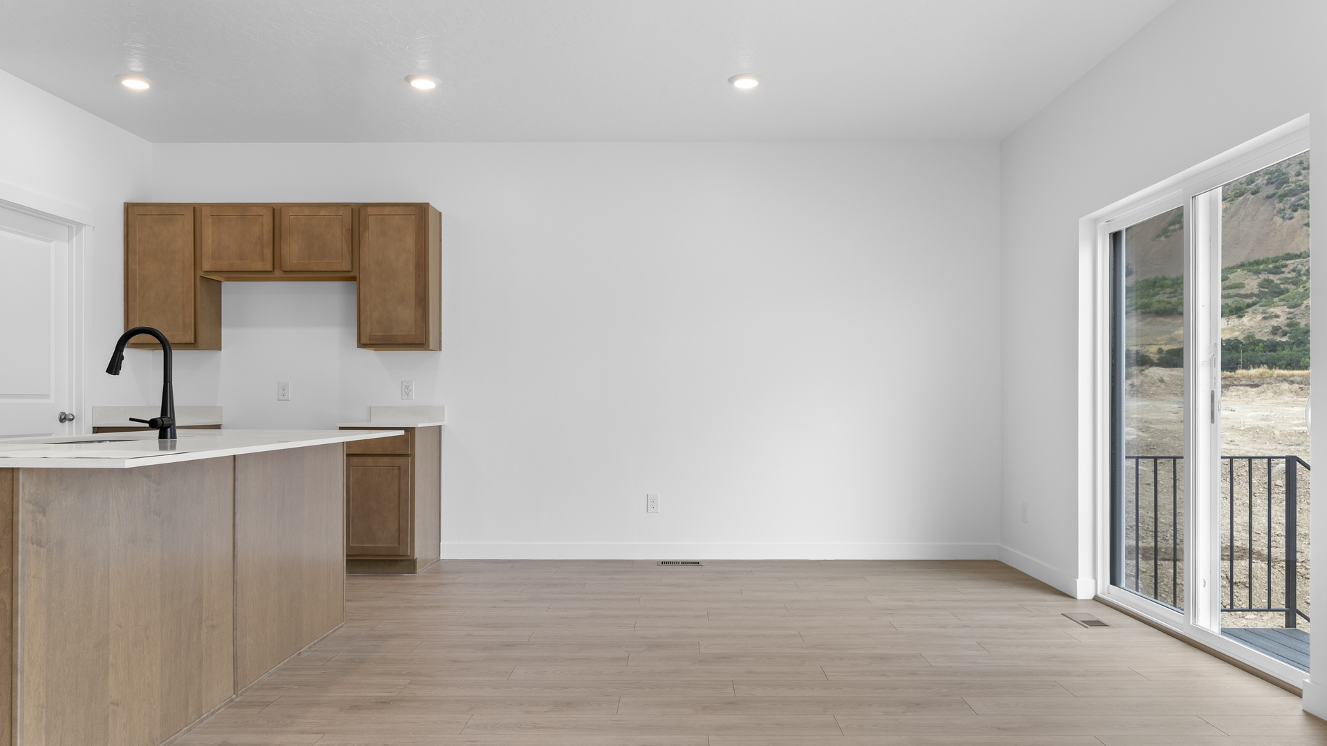 Kitchen space with kitchen island and stainless steel appliances.
