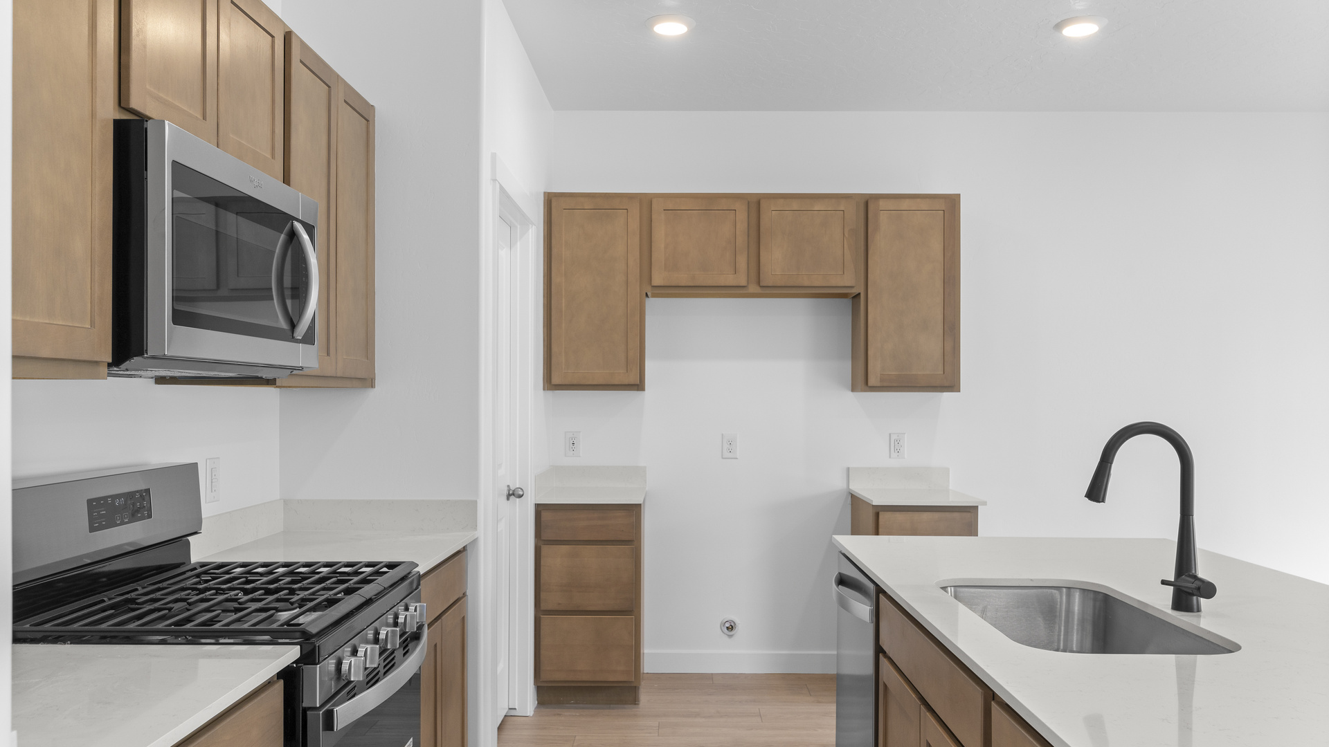 Kitchen space with kitchen island and stainless steel appliances.
