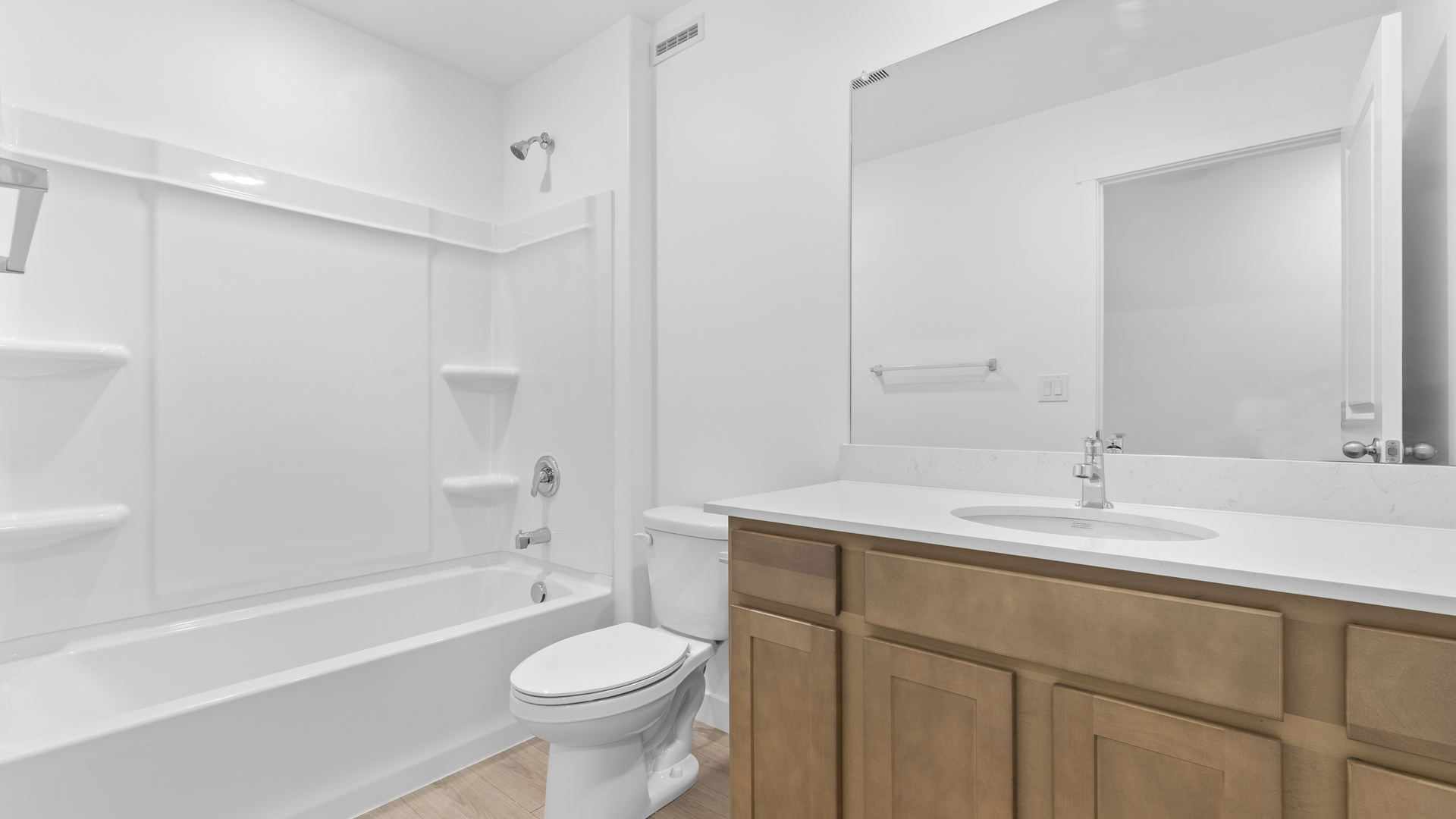 Bathroom with large vanity and shower surround.