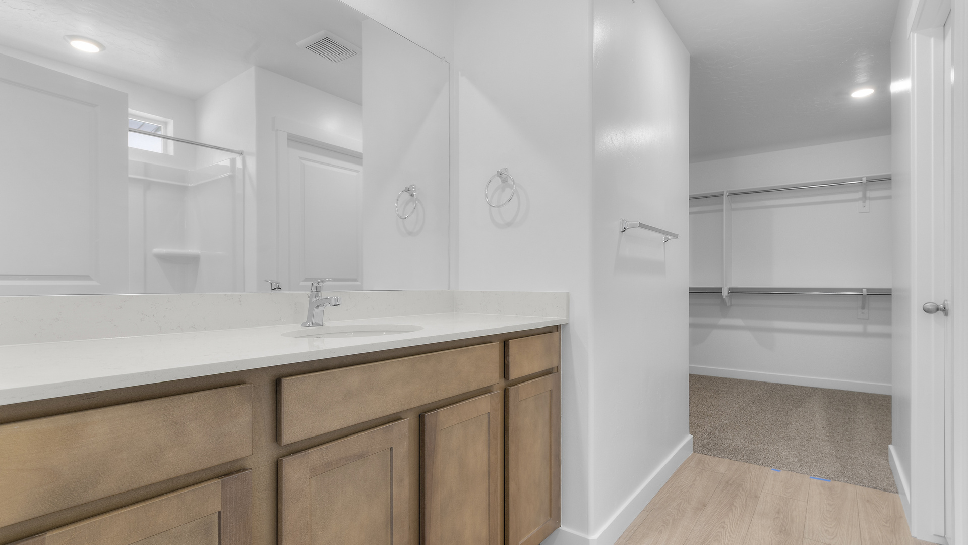 Primary bathroom with large vanity and shower surround.