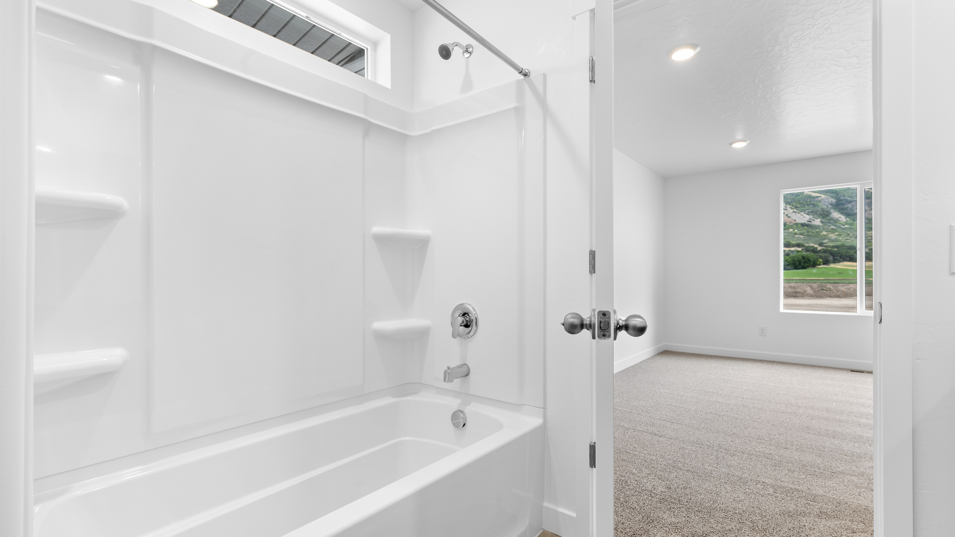 Primary bathroom with large vanity and shower surround.