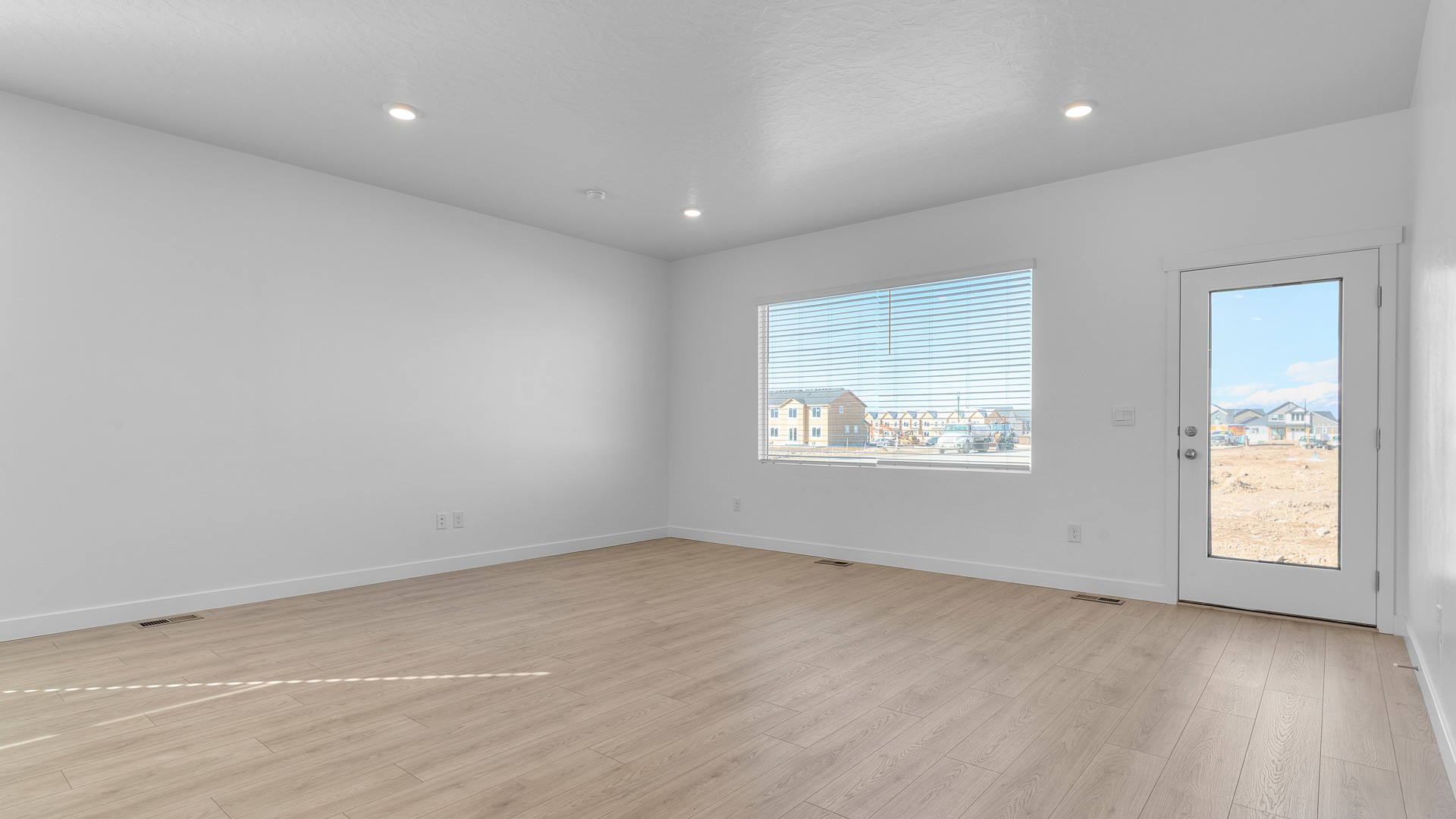 Family room with large window and door out back.