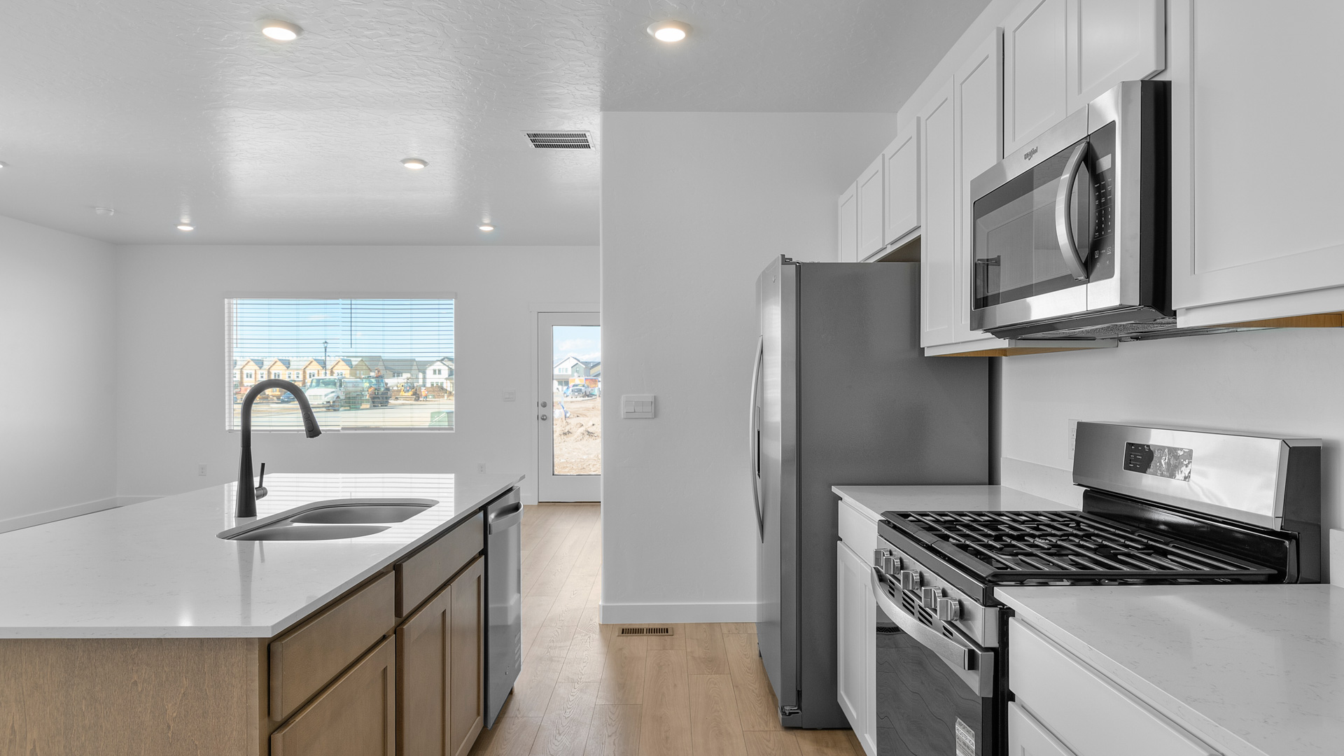 Kitchen with two tone cabinets and kitchen island.