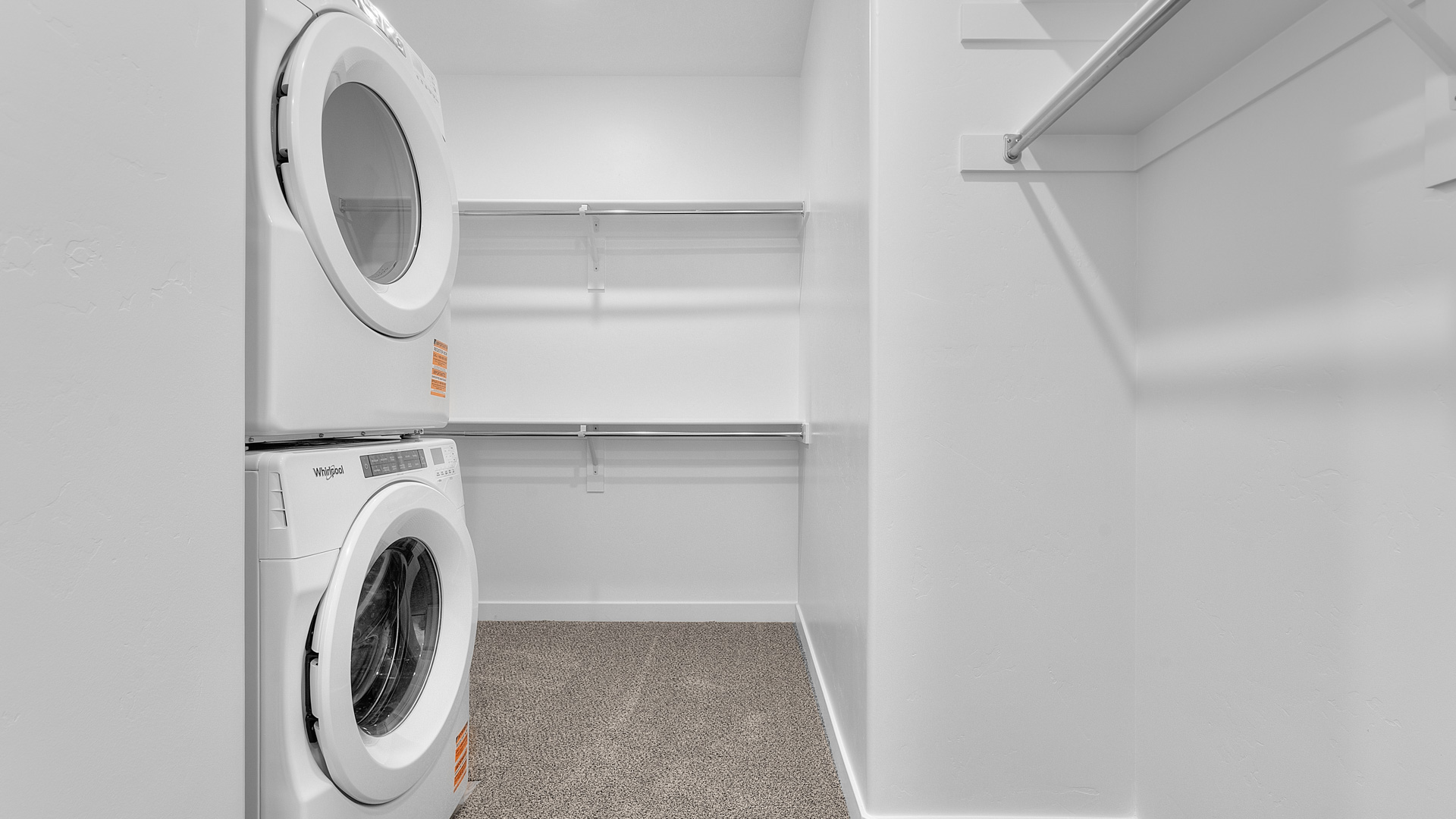 Laundry unit inside large walk-in closet.