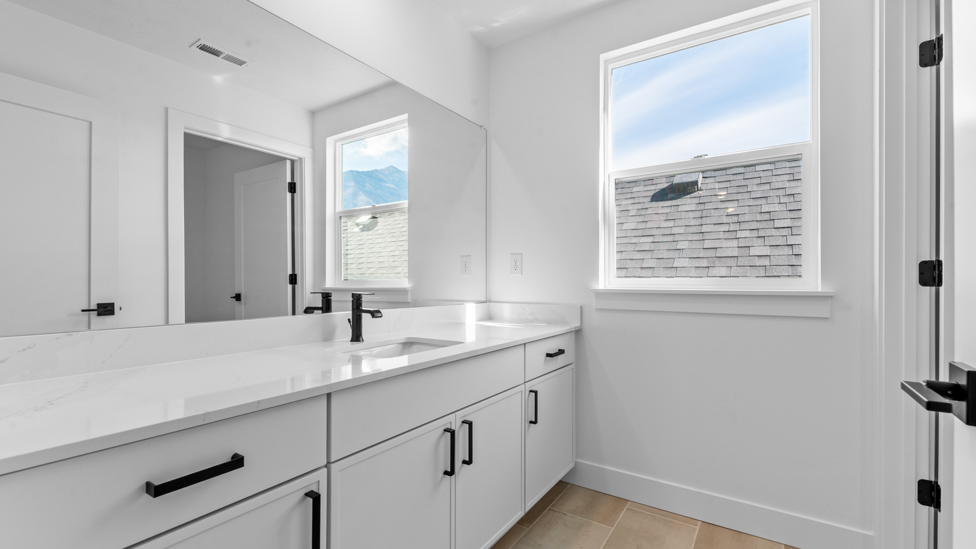 Bathroom with large vanity and window.