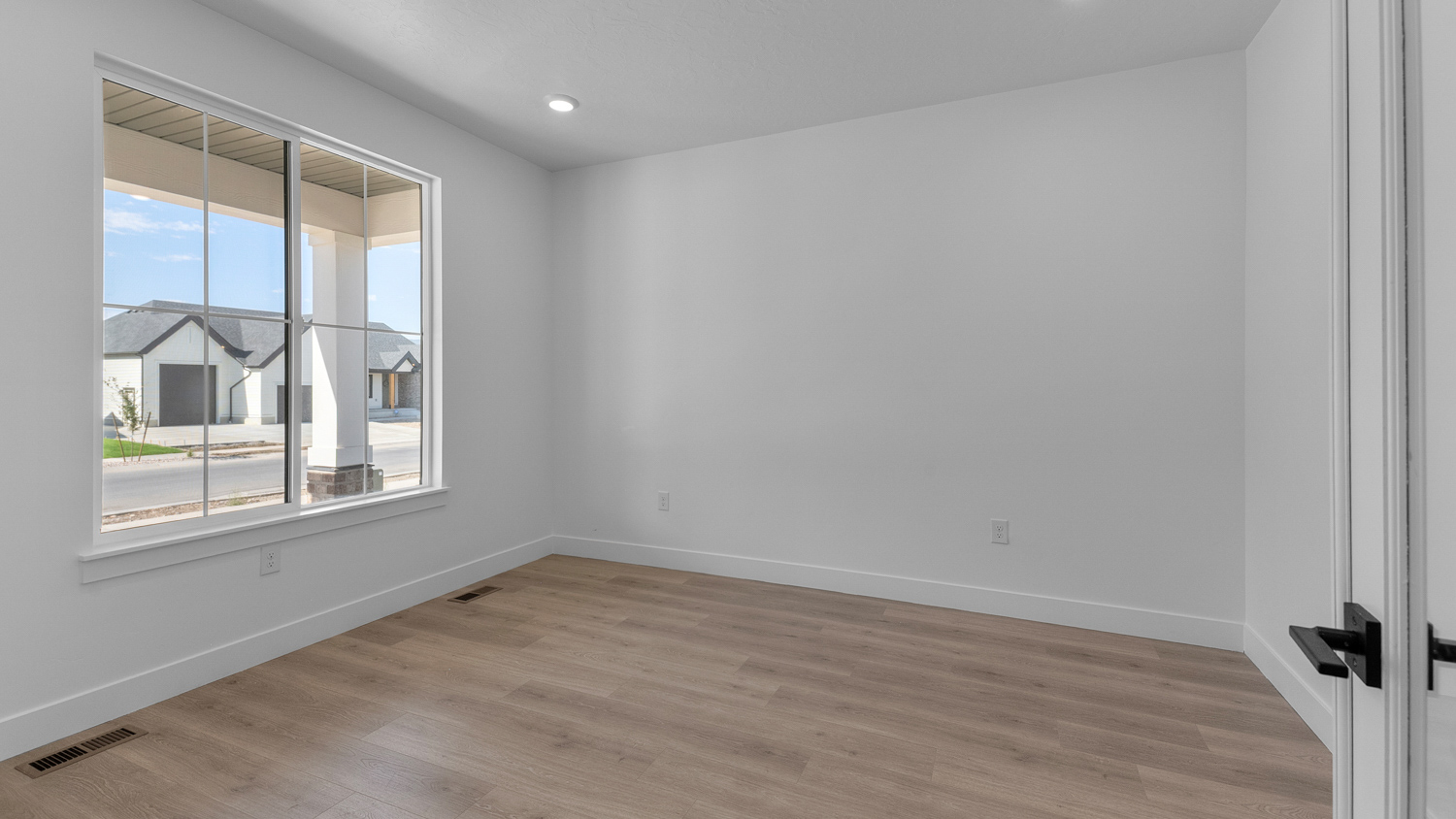 Office space with double doors and large window.