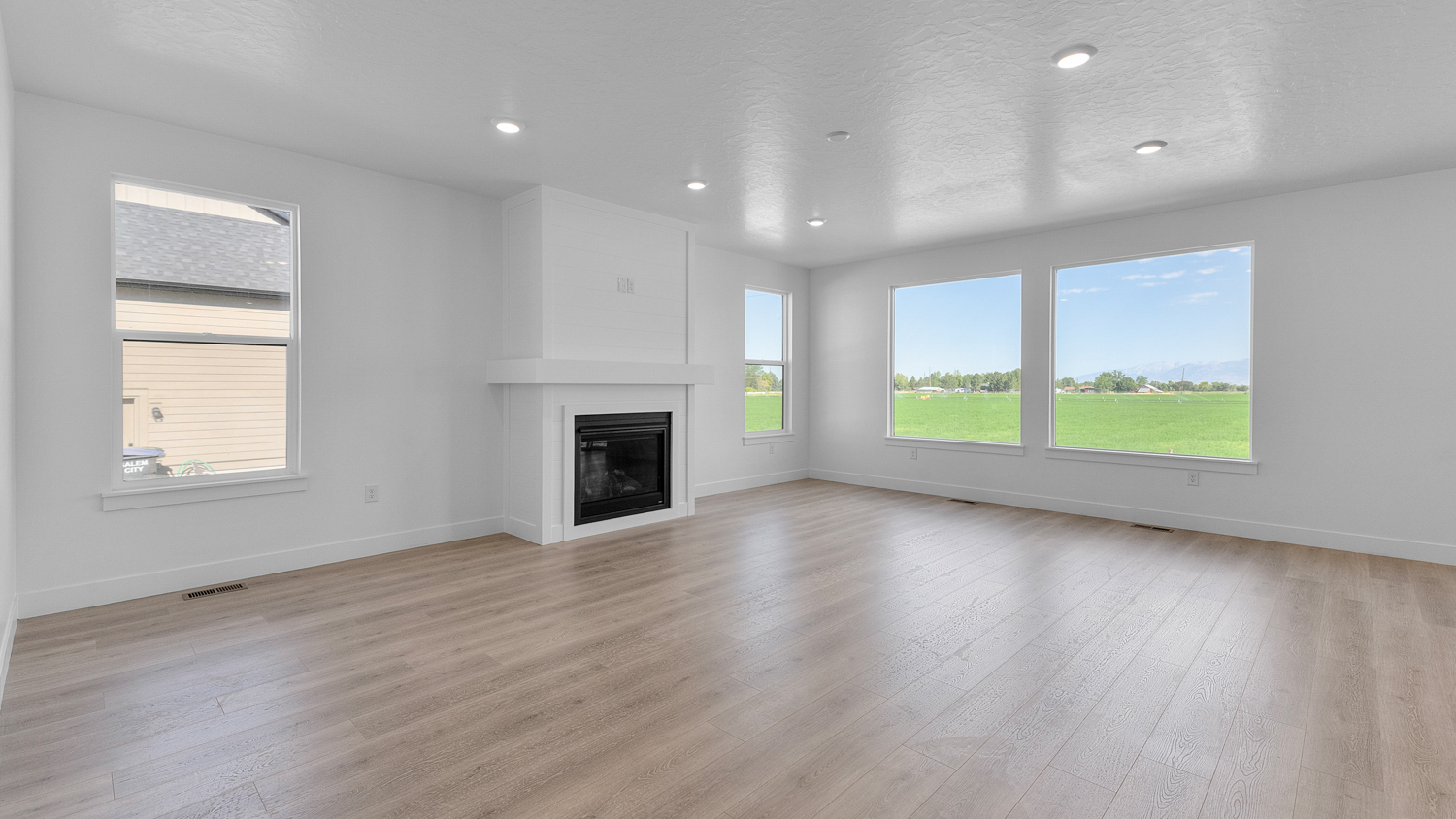 Family room with fireplace and large windows.