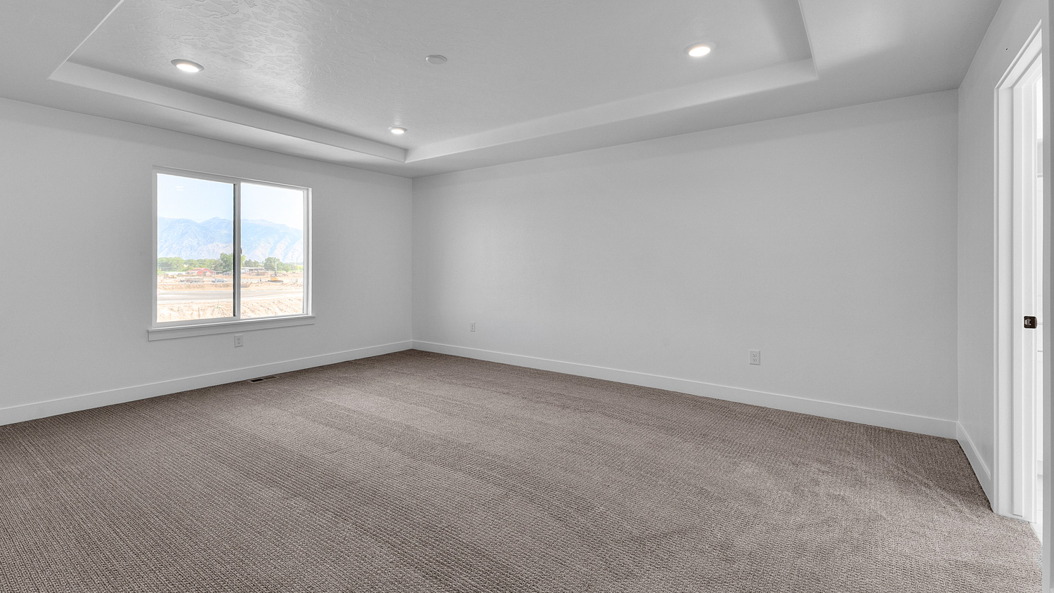 Primary bedroom with large window.