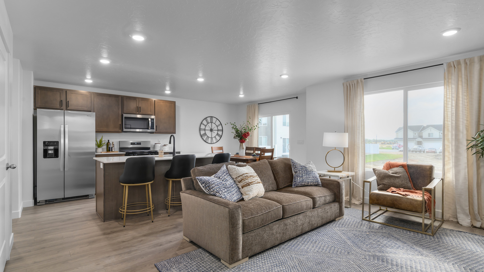 View of spacious living room with large window.