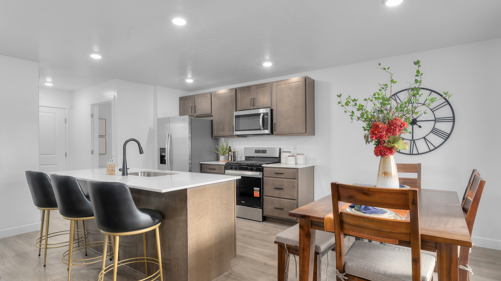 Kitchen with island including sink and kitchen featuring appliances and cabinets.