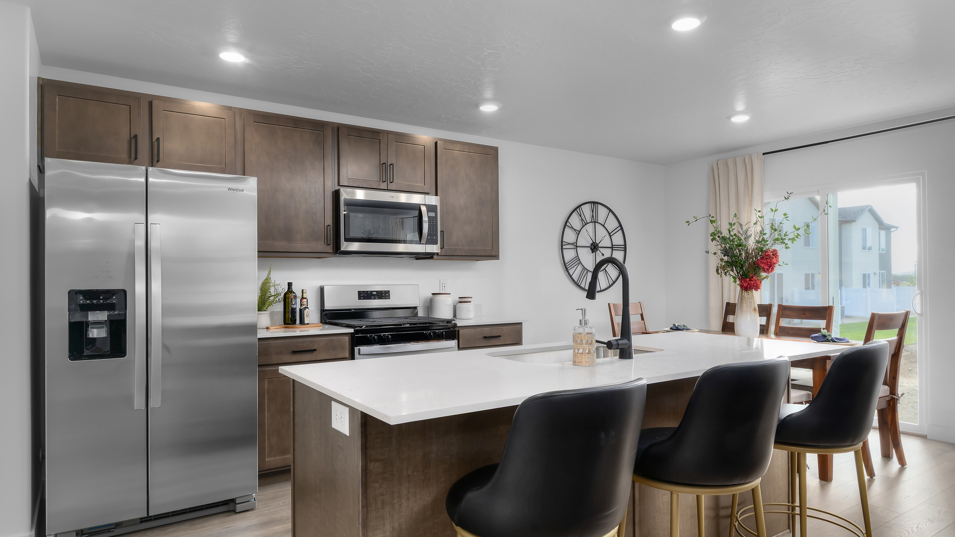 Kitchen with island including sink and kitchen featuring appliances and cabinets.