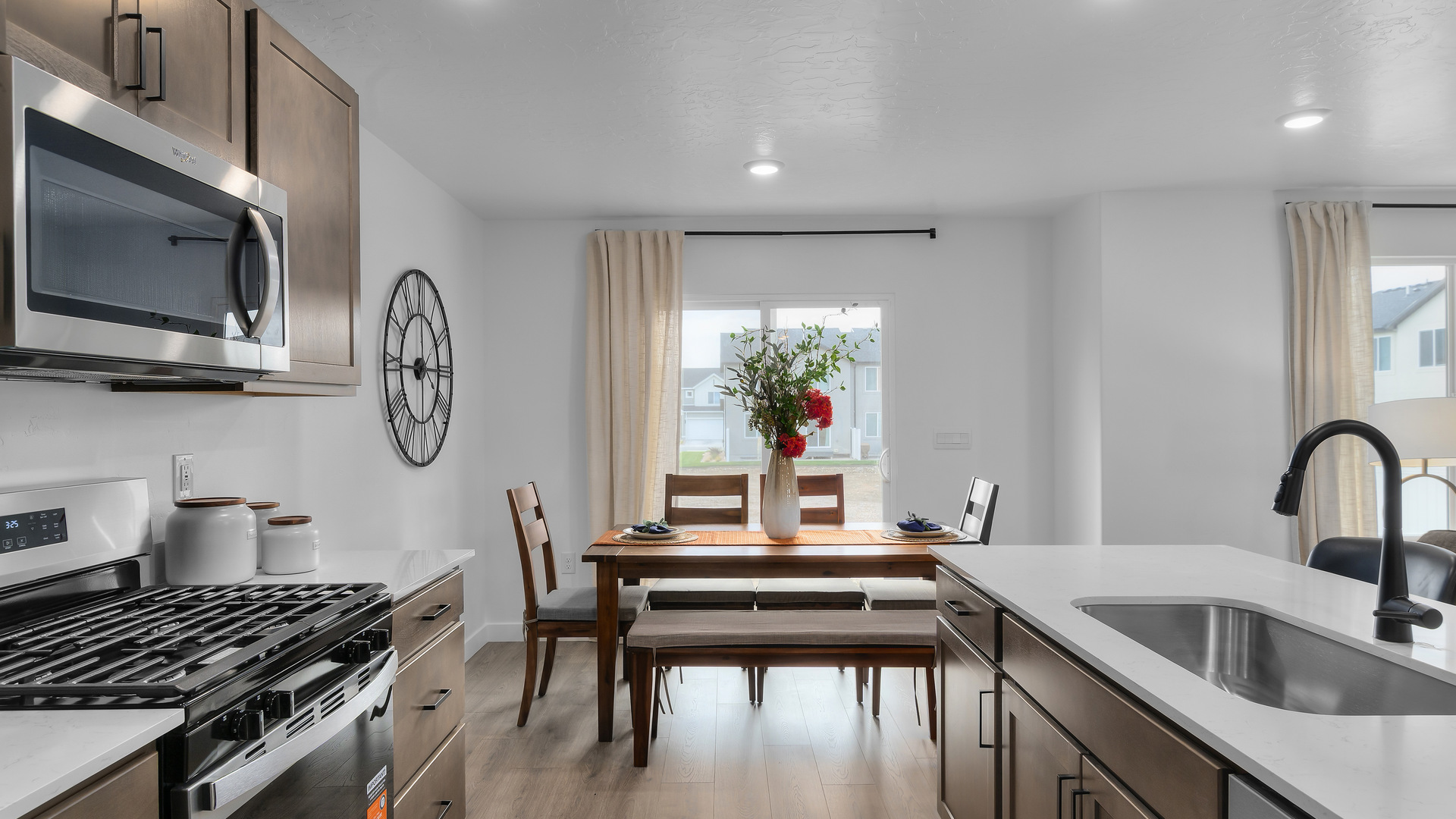 Kitchen with island including sink and kitchen featuring appliances and cabinets.